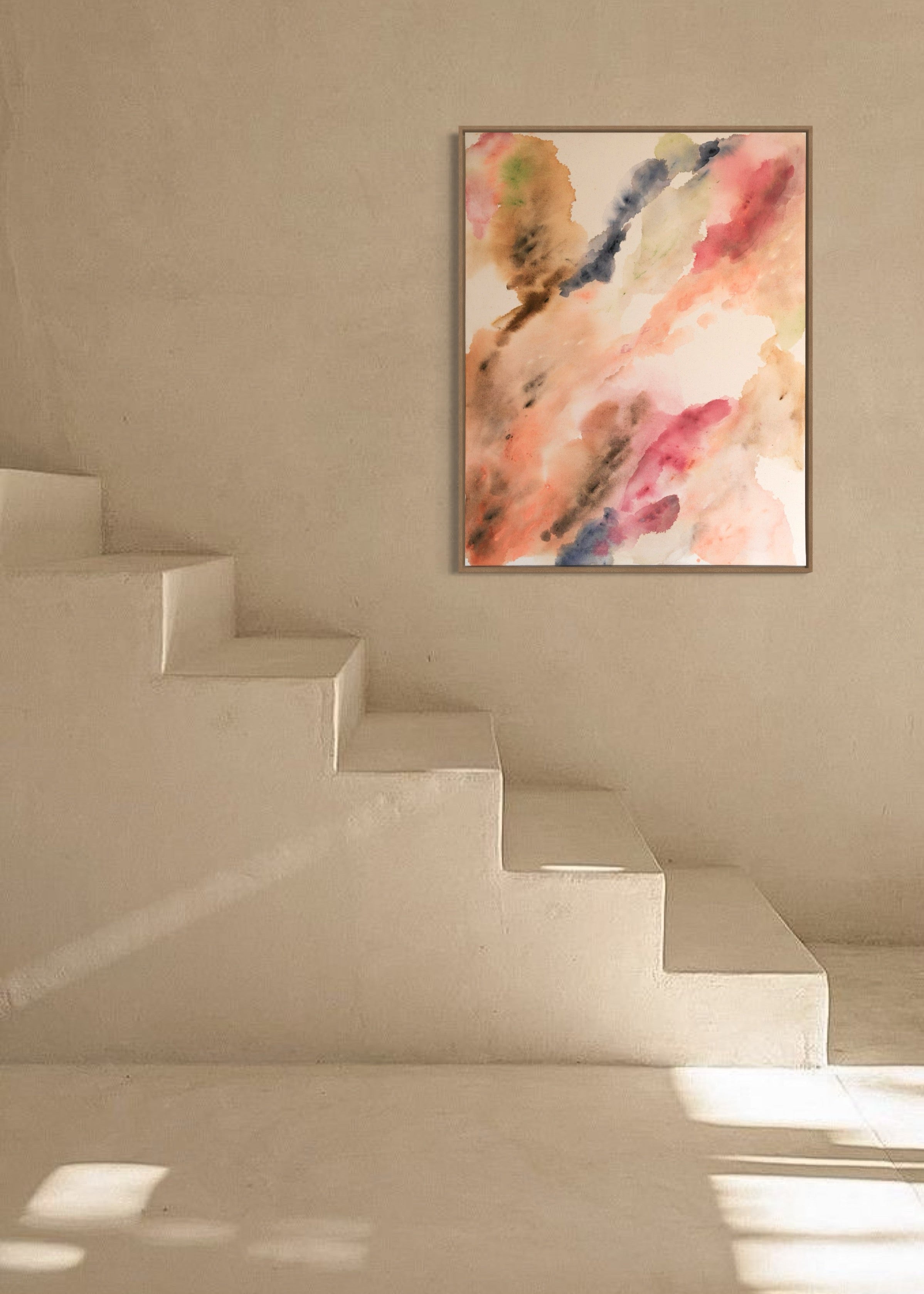 Abstract watercolor in earthy tones such as beige, rose, orange, and brown, with touches of blue and green. The colors flow transparently into one another on a white background, framed in a slim, wooden frame.