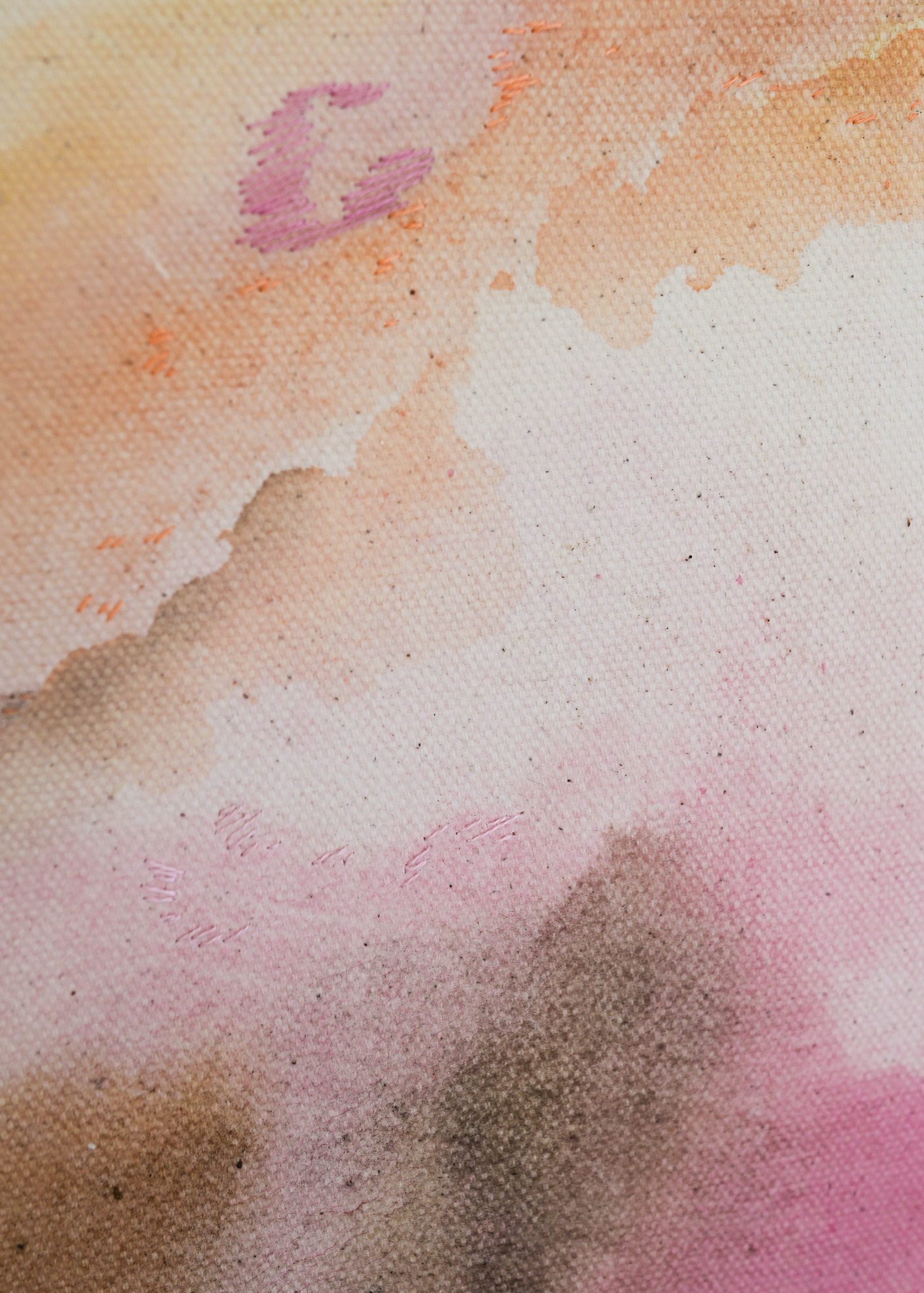 Abstract watercolor in earthy tones such as beige, rose, orange, and brown, with touches of blue and green. The colors flow transparently into one another on a white background, framed in a slim, wooden frame.