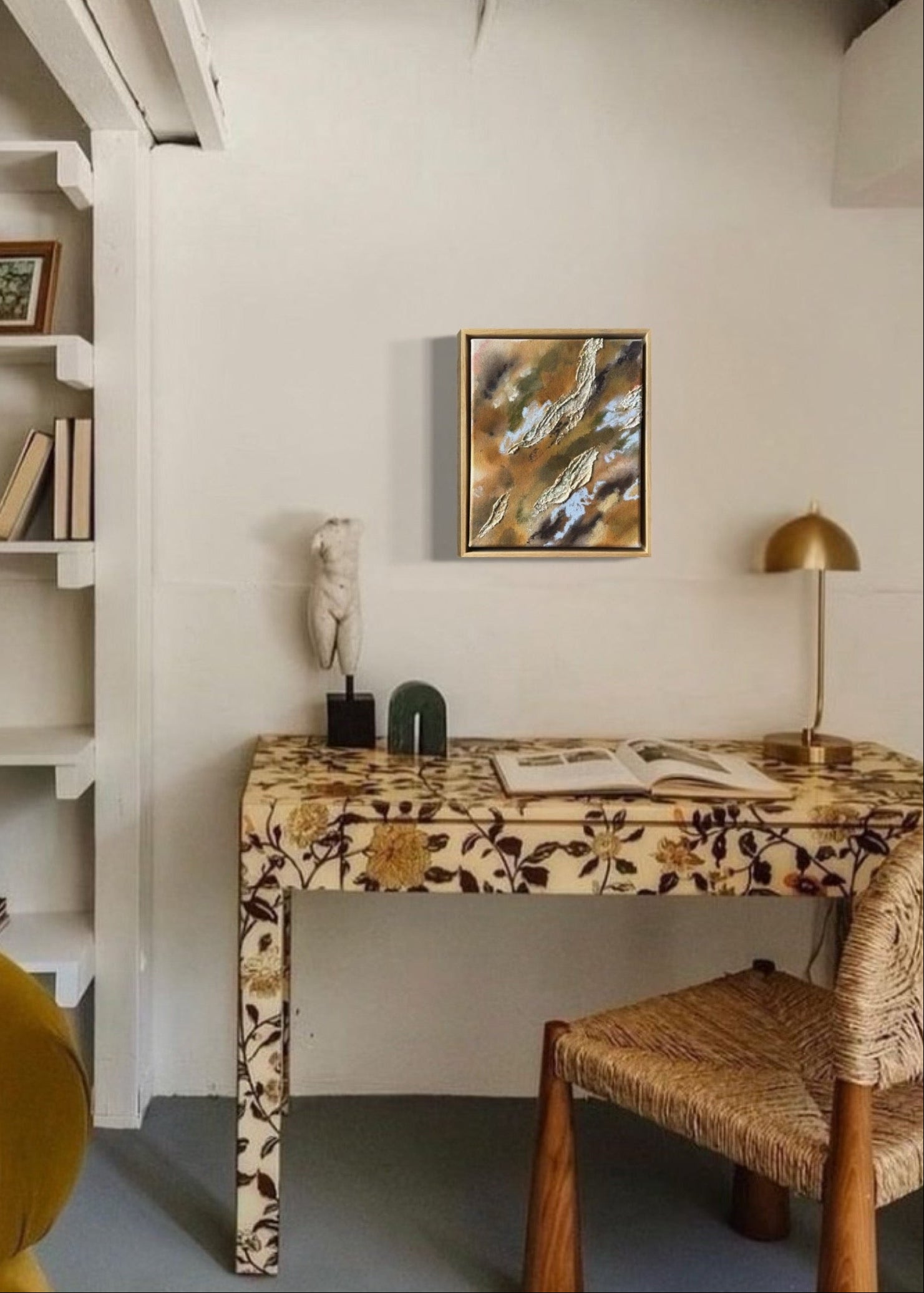 Abstract painting with textured, layered elements in shades of brown, green, and blue. The canvas features irregular shapes resembling organic forms. Framed in oak wood.