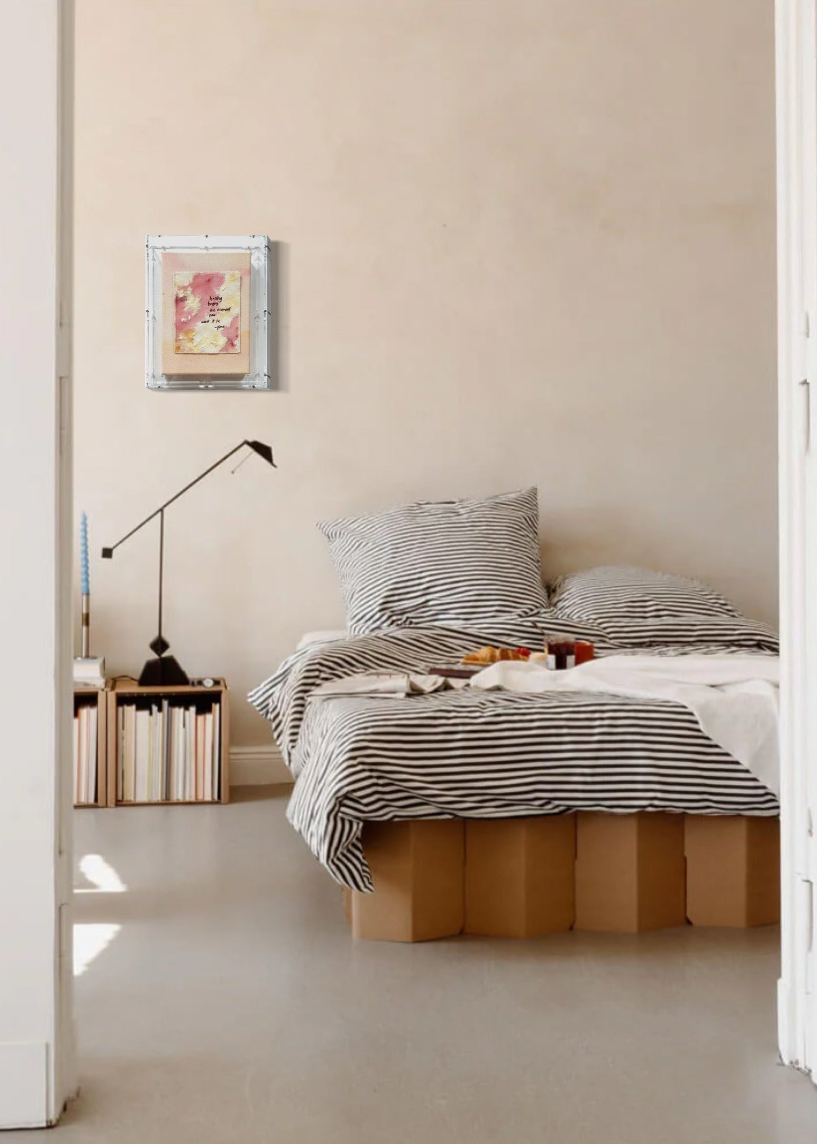 The abstract painting features a soft pink, beige, and orange watercolor background. It has a hand-stitched poem that says, "Healing begins the moment you want it to." This artwork radiates hope and is beautifully framed in clear acrylic.