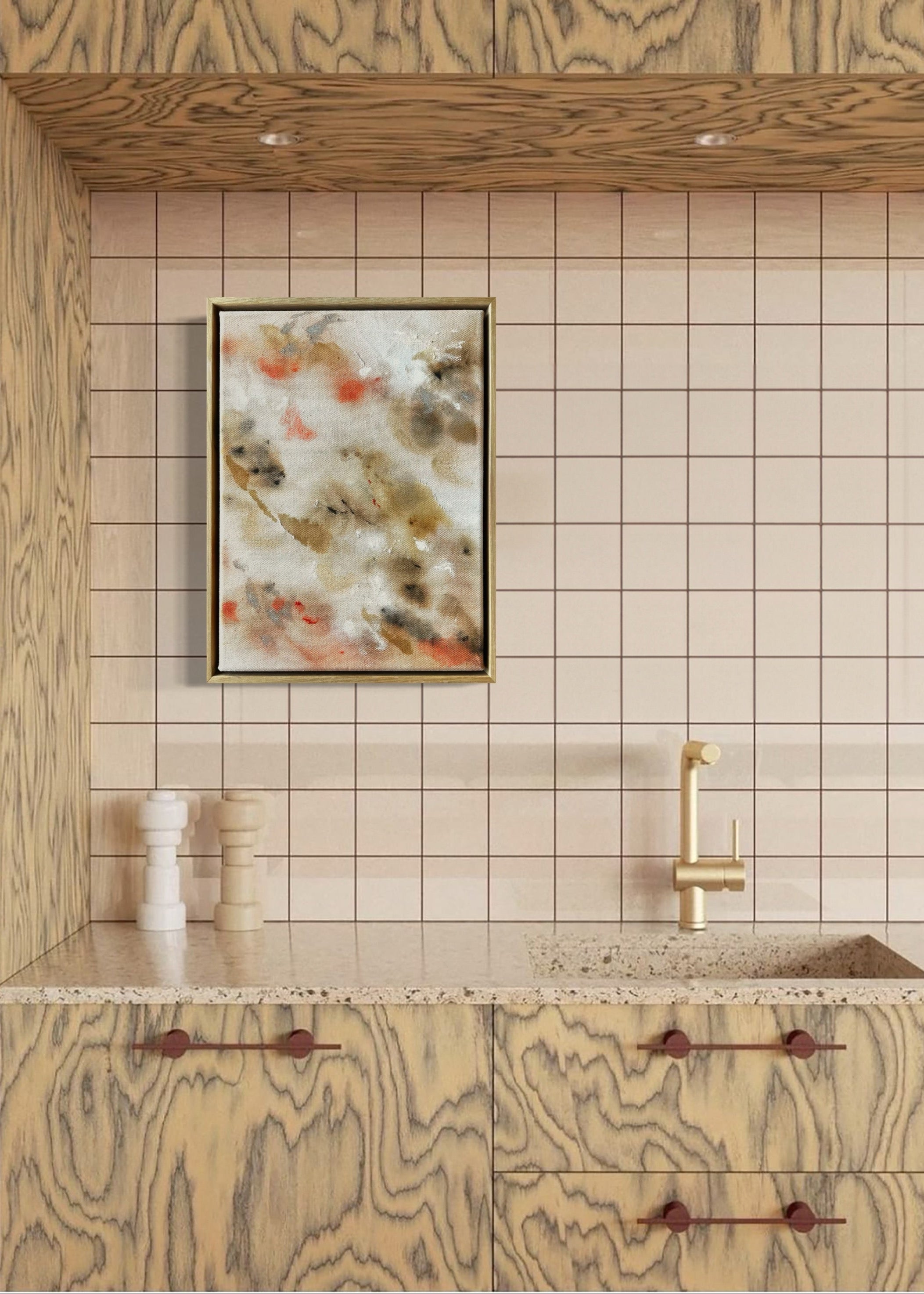 Abstract painting featuring soft, blended shapes in beige, brown, and hints of orange. The artwork has a textured, stitched surface and is framed in a light oak wood frame.