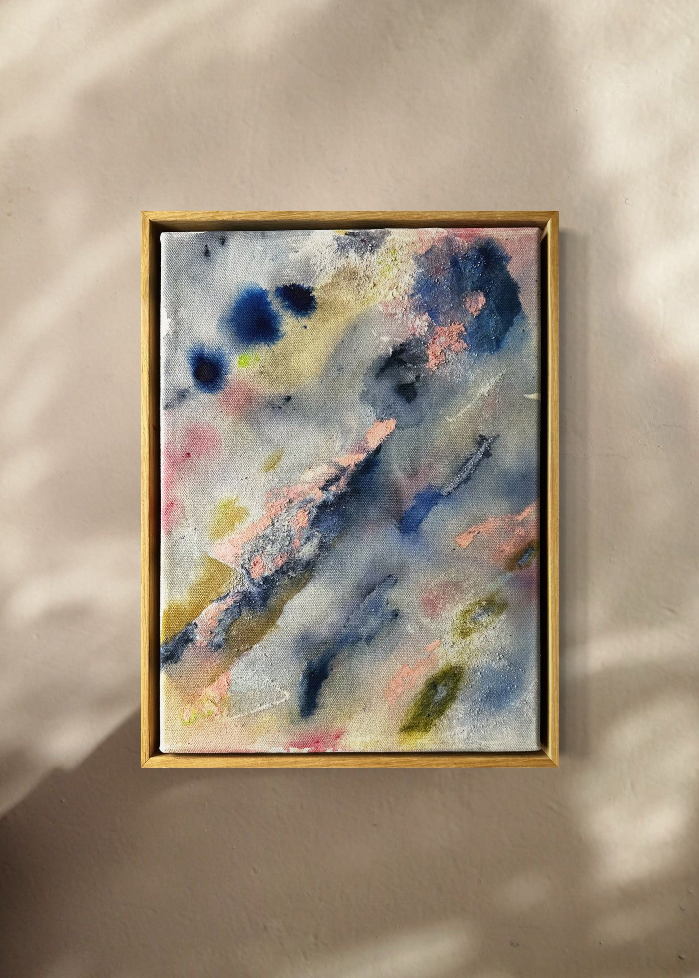 Abstract painting with a textured surface featuring blue, pink, and green hues. The composition includes various brush strokes and splatters.