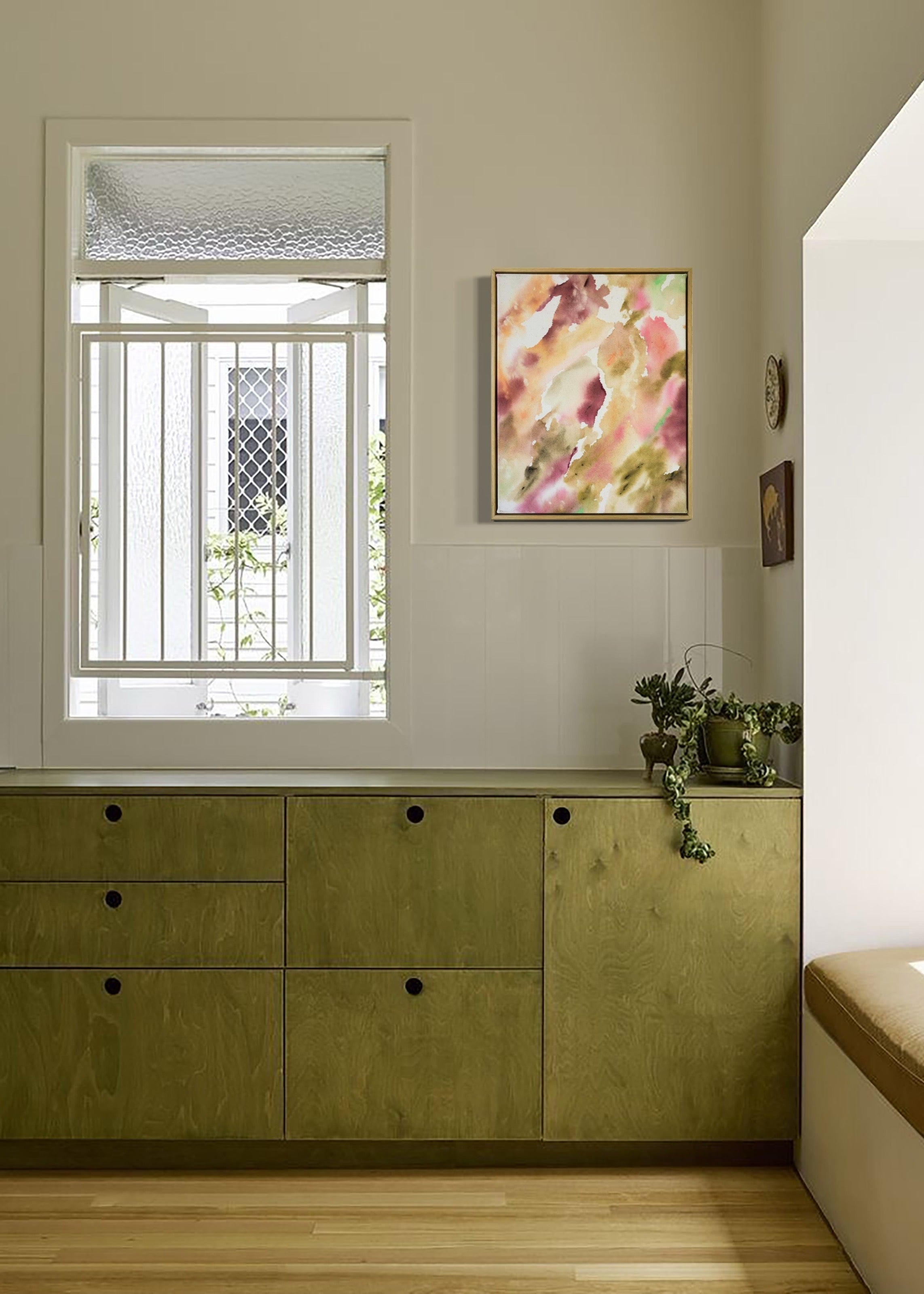 Abstract painting featuring soft, flowing shapes in shades of pink, beige, orange, and green shades, with a textured appearance framed in oak wood.