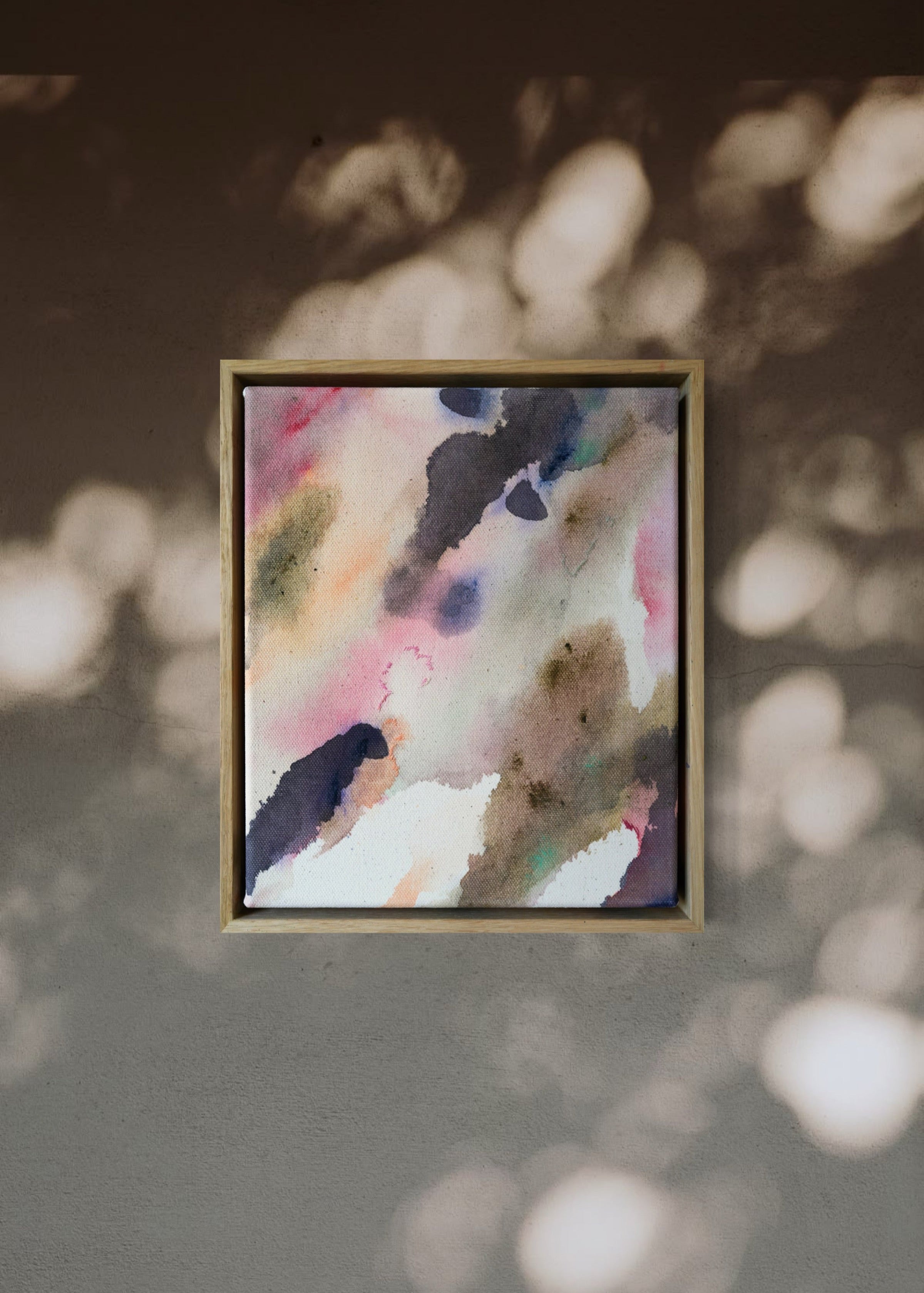 Abstract acrylic painting with soft swirls of pink, purple, and earthy tones, framed in wood. It conveys a serene, dreamy ambiance.
