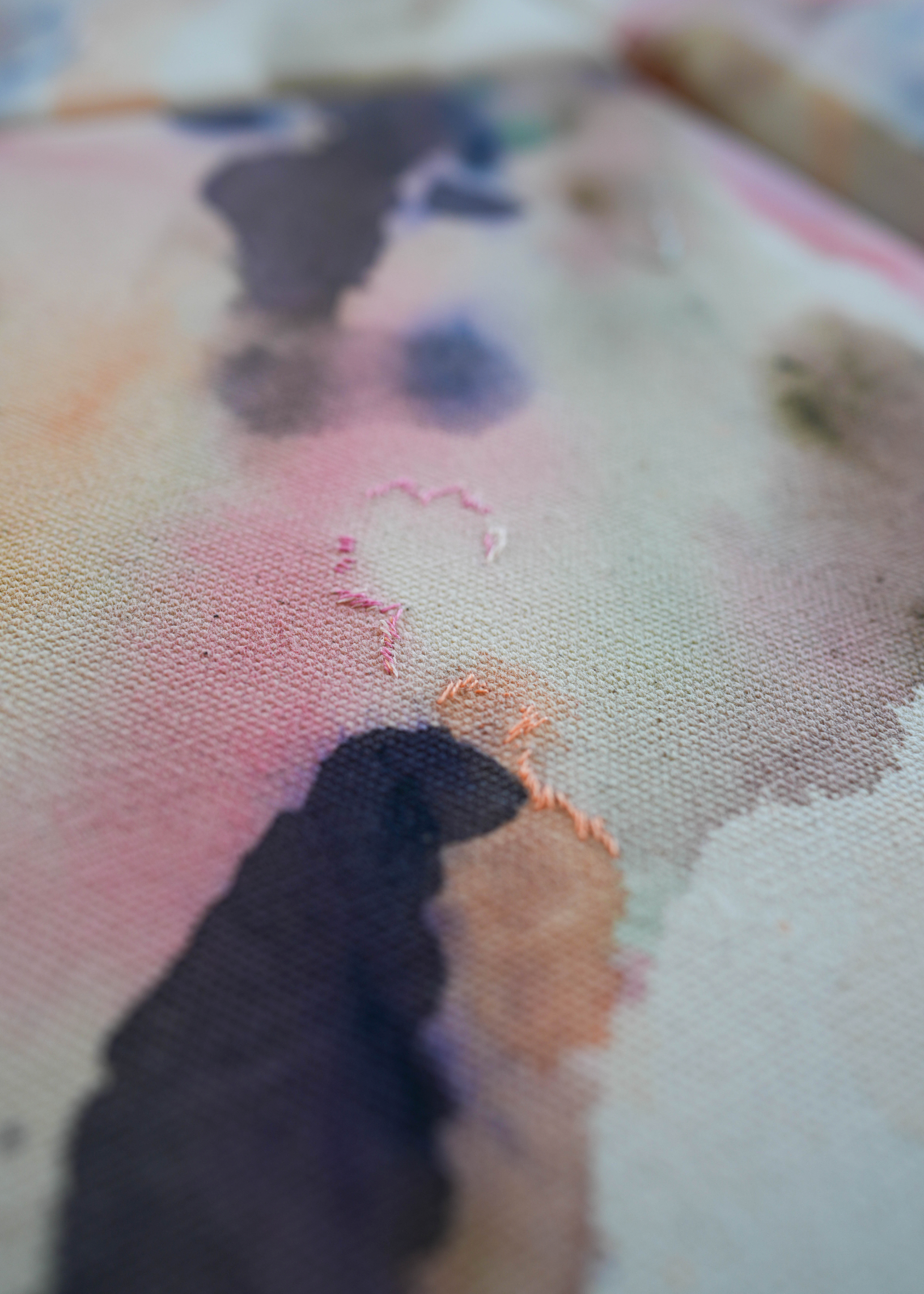 Abstract acrylic painting with soft swirls of pink, purple, and earthy tones, framed in wood. It conveys a serene, dreamy ambiance.