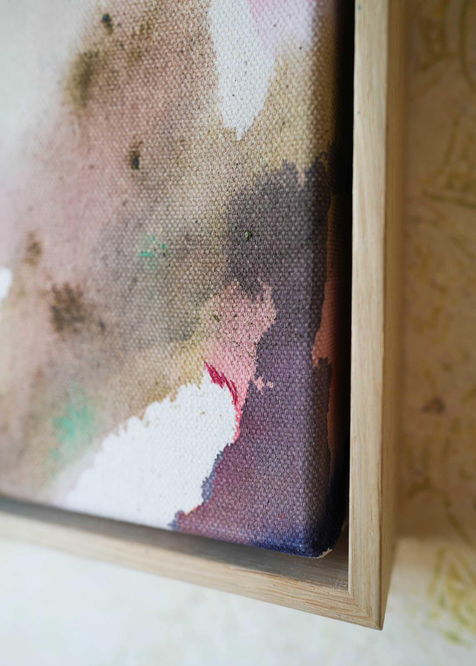 Abstract acrylic painting with soft swirls of pink, purple, and earthy tones, framed in wood. It conveys a serene, dreamy ambiance.