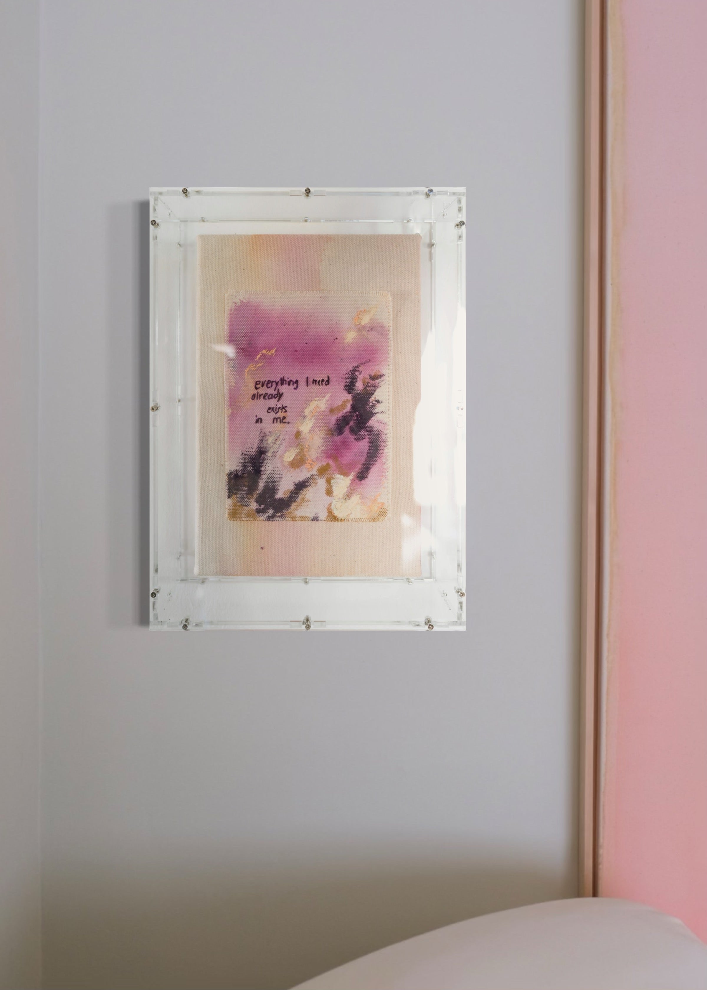 Abstract painting featuring purple, dark purple, and beige brushstrokes on canvas. With a stitched poem that reads, "everything I need already exists in me." Framed in clear acrylic.