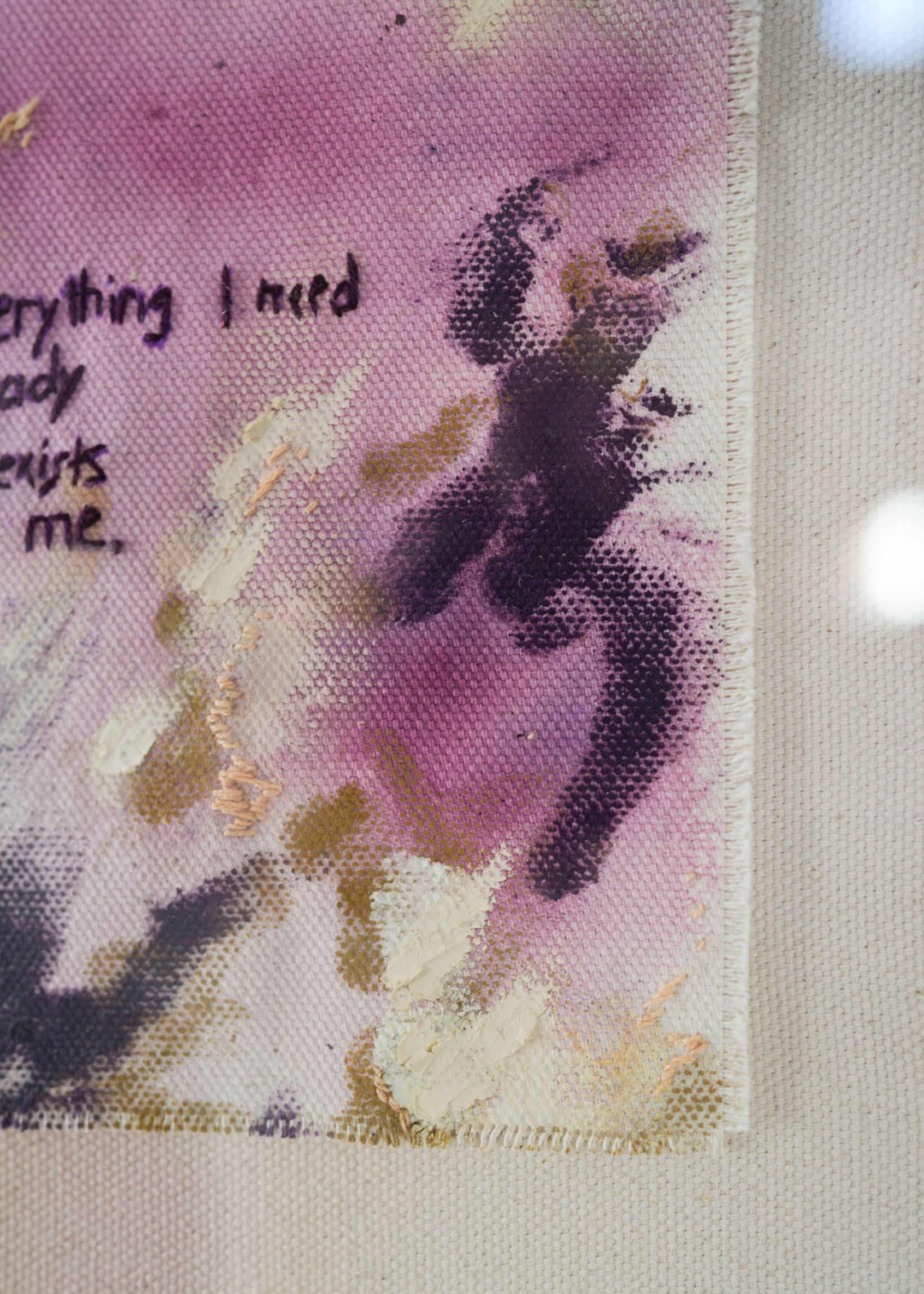 Abstract painting featuring purple, dark purple, and beige brushstrokes on canvas. With a stitched poem that reads, "everything I need already exists in me." Framed in clear acrylic.
