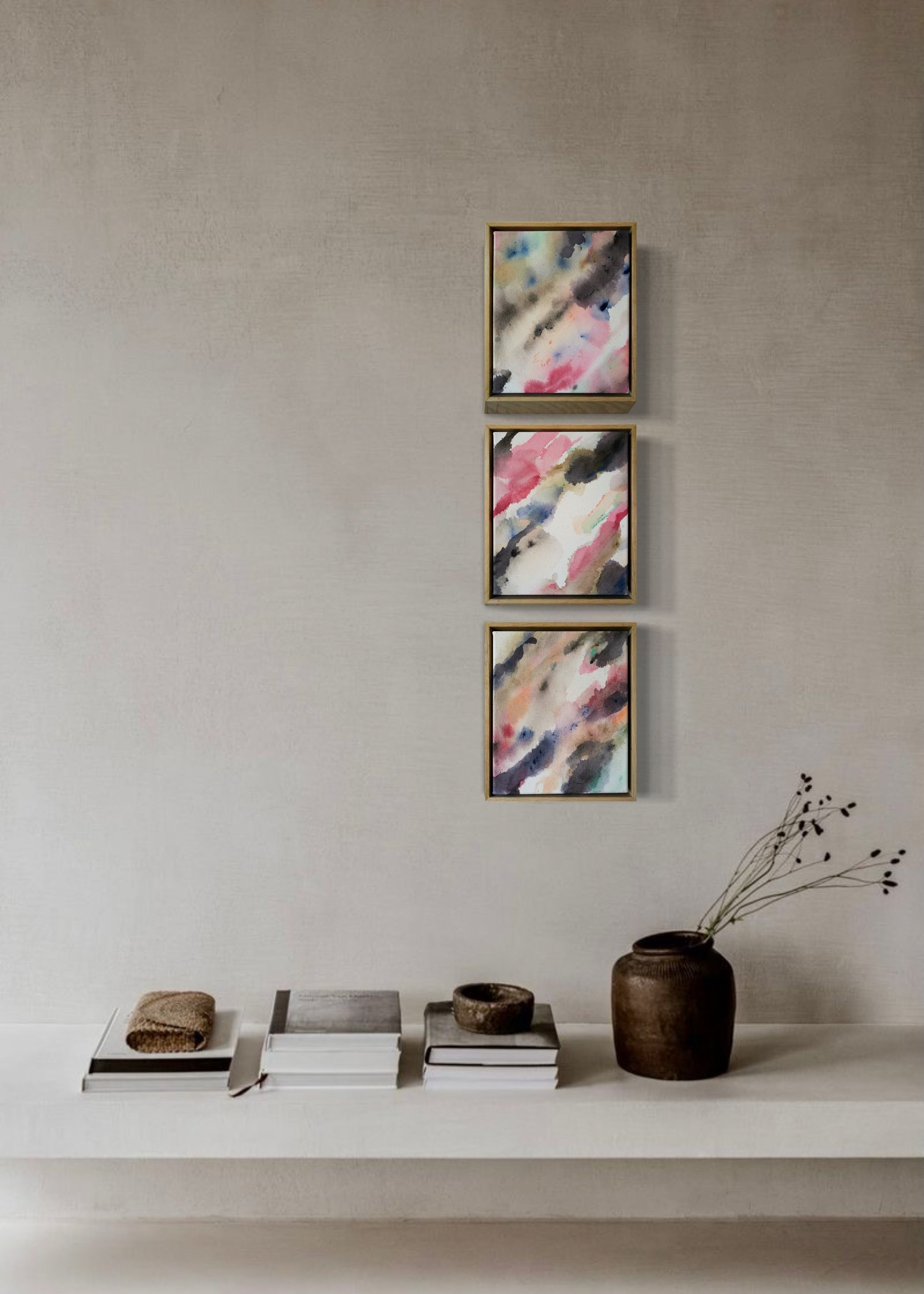Abstract acrylic painting with flowing shades of pink, brown, and gray on canvas, in a wooden frame. The soft brushstrokes convey a soothing, dreamy emotion.
