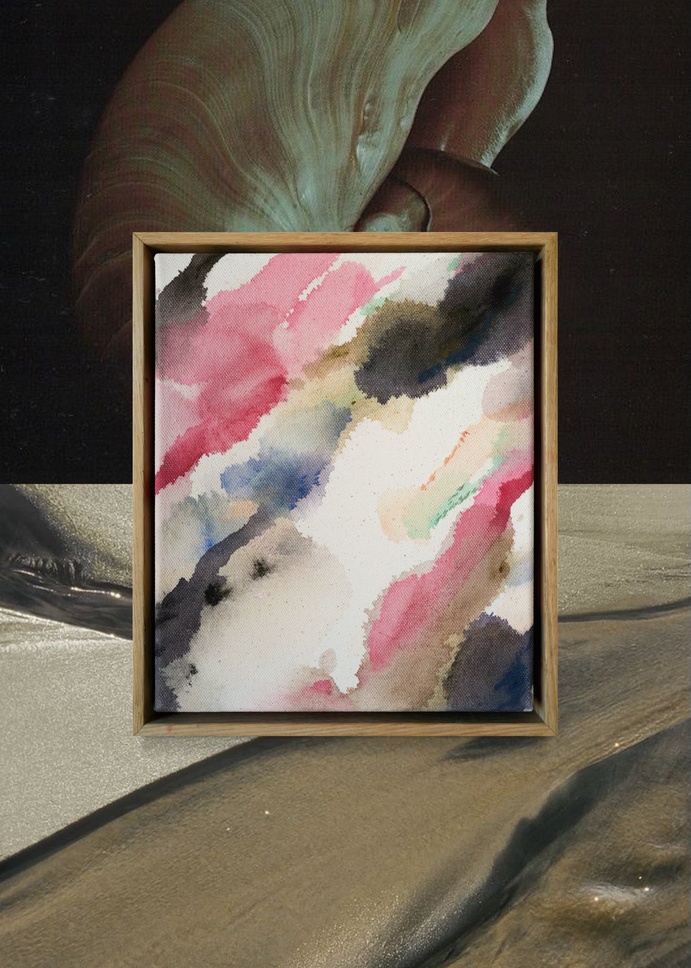 Abstract acrylic watercolor painting in a wooden frame. Soft pink, grey, and brown hues blend on a raw canvas, creating a calm, fluid effect.