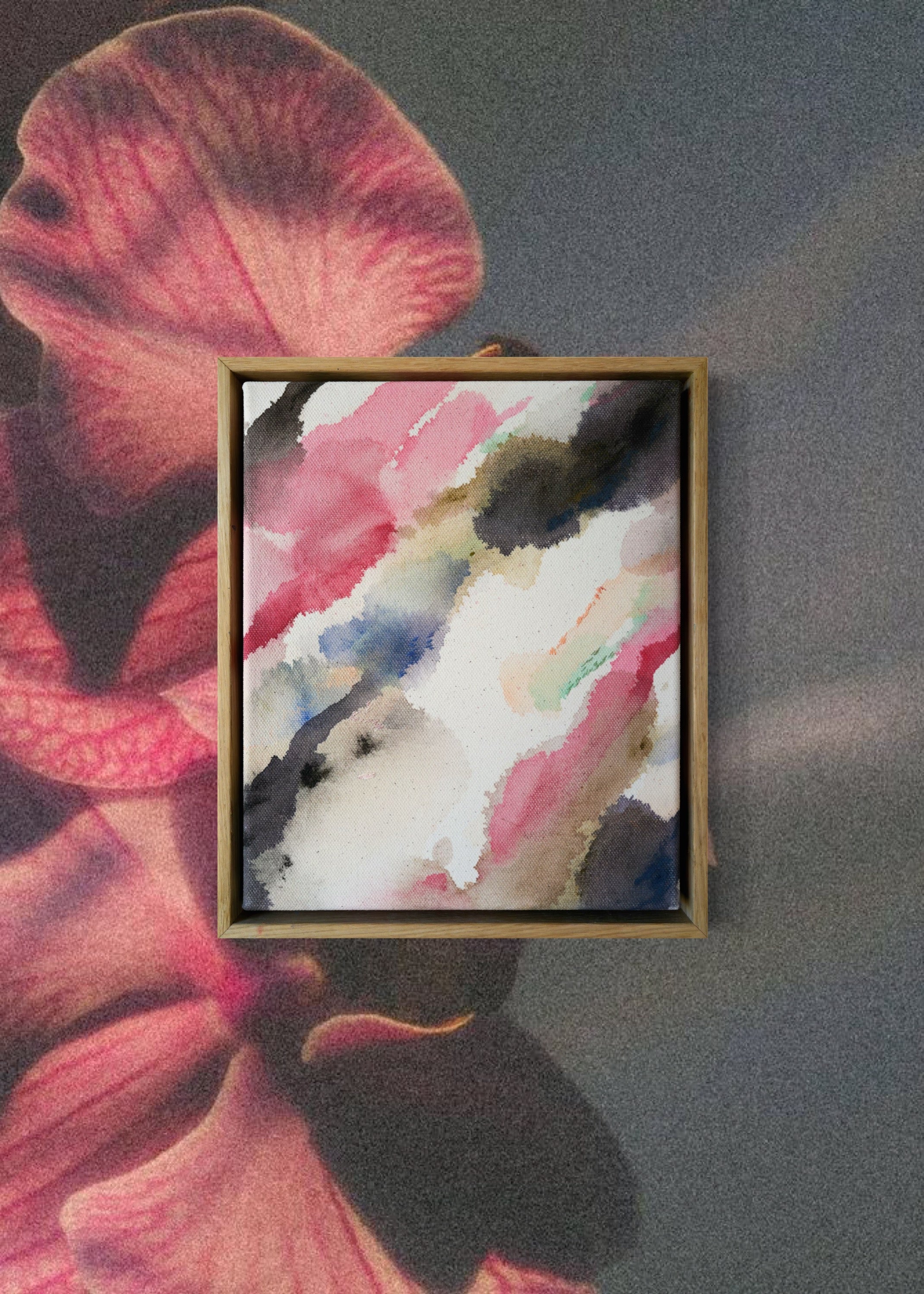 Abstract acrylic watercolor painting in a wooden frame. Soft pink, grey, and brown hues blend on a raw canvas, creating a calm, fluid effect.