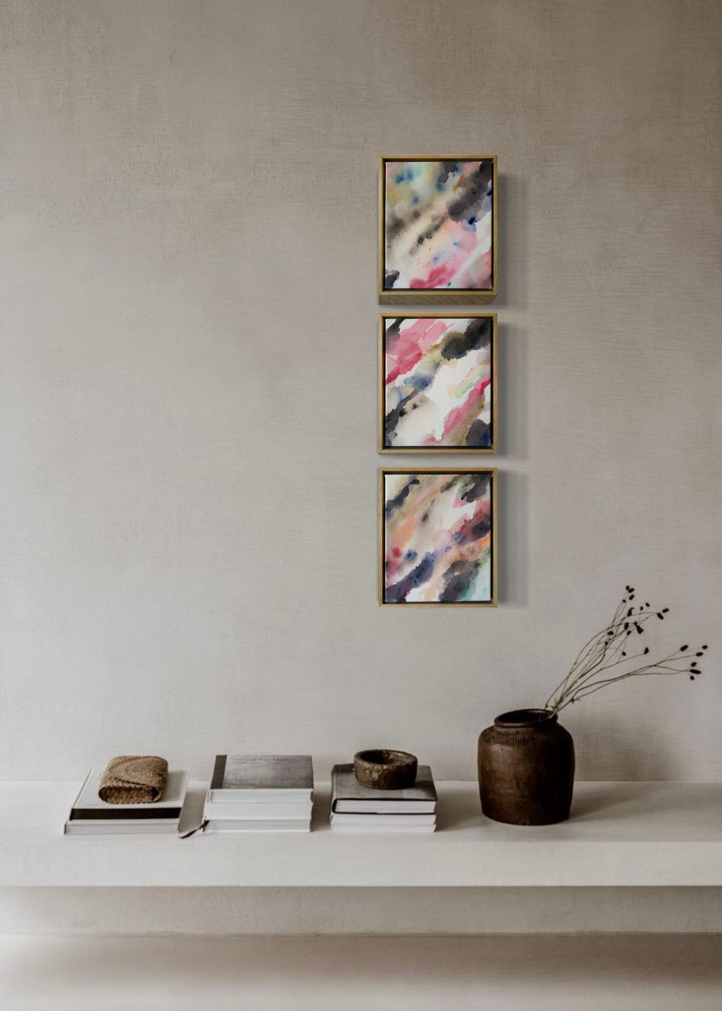 Abstract acrylic, fuid painting in a wooden frame, featuring soft blends of pink, blue, and dark grey. Conveys a dreamy, ethereal mood.