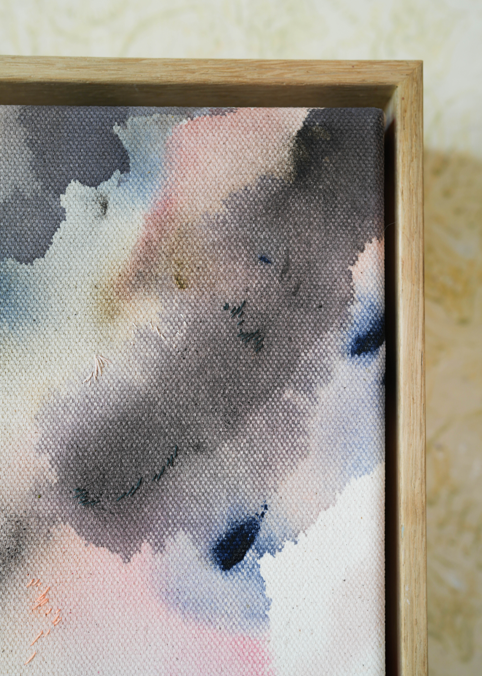 Abstract acrylic, fuid painting in a wooden frame, featuring soft blends of pink, blue, and dark grey. Conveys a dreamy, ethereal mood.