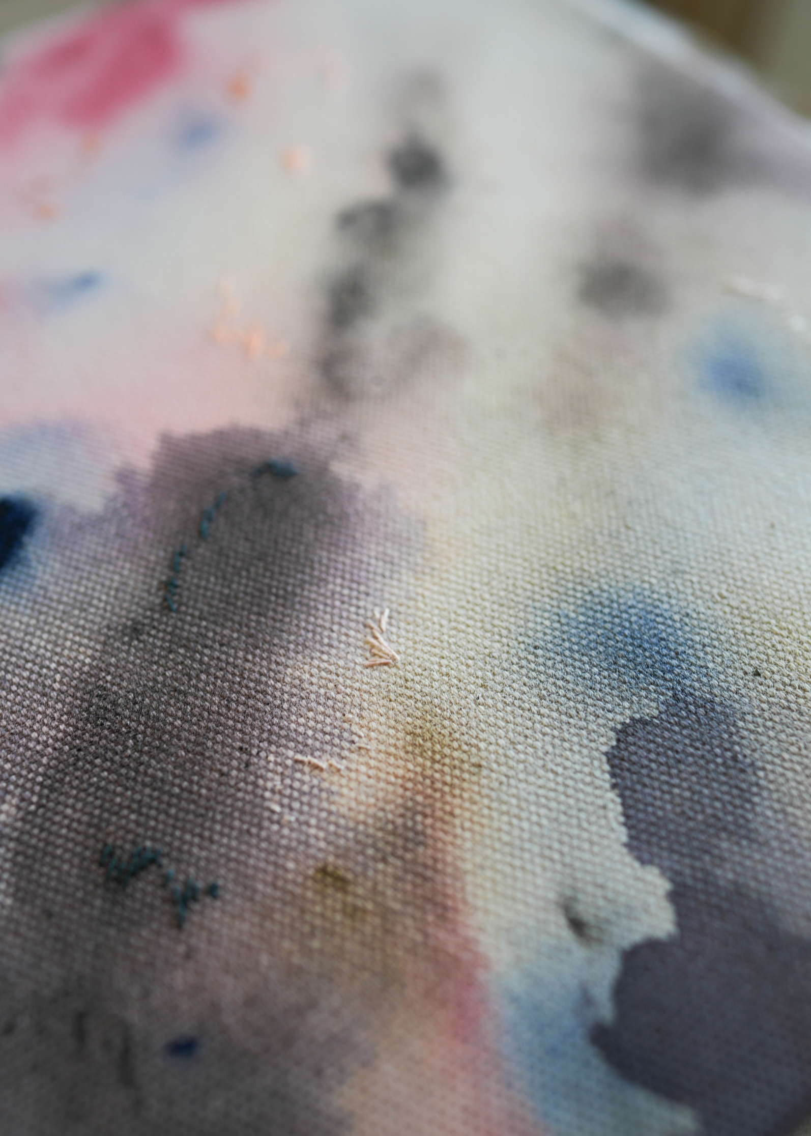 Abstract acrylic, fuid painting in a wooden frame, featuring soft blends of pink, blue, and dark grey. Conveys a dreamy, ethereal mood.