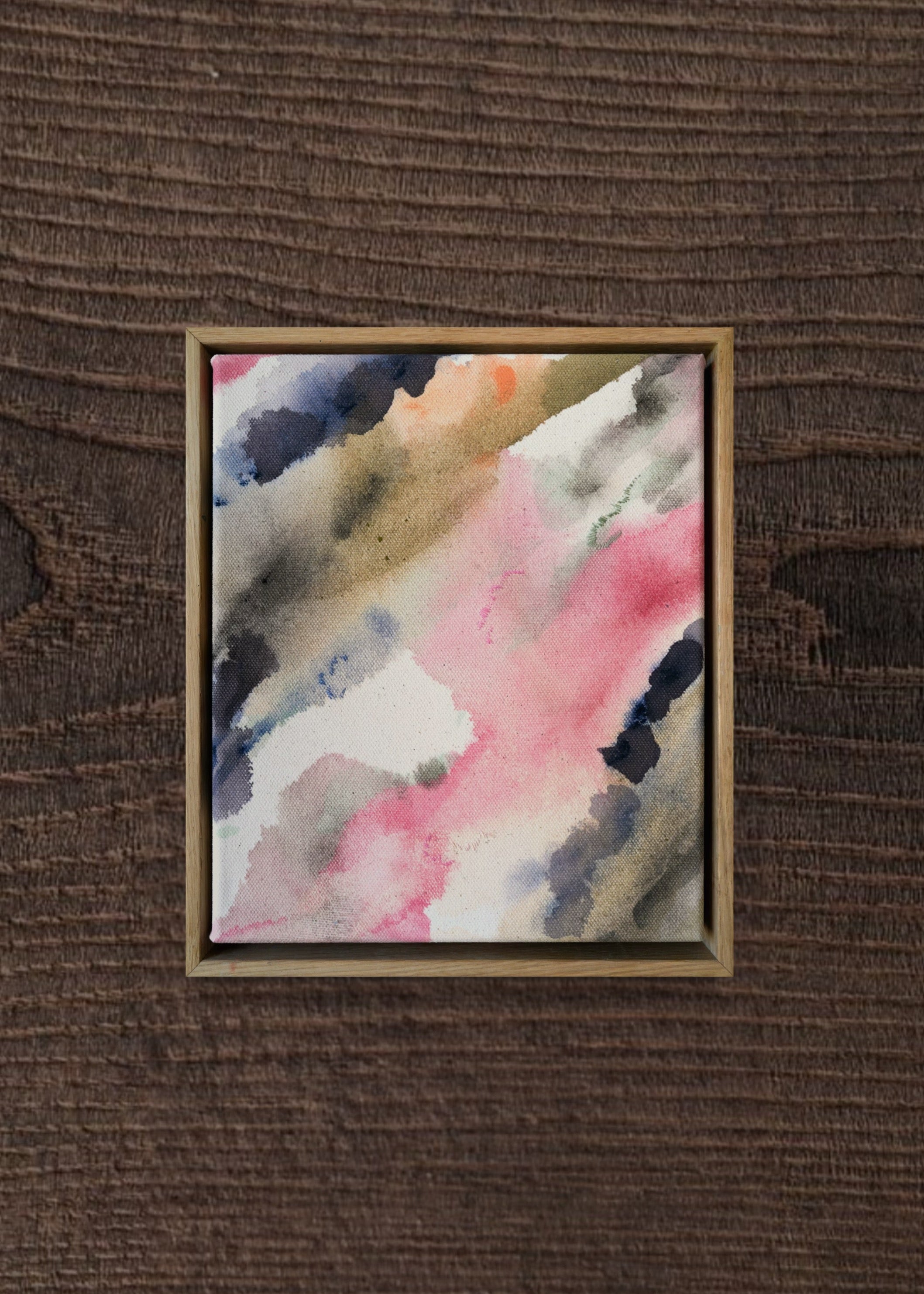 Abstract acrylic painting with pink, blue, and gray hues on raw canvas. Bordered by a wooden frame. Conveys a natural, ethereal mood.
