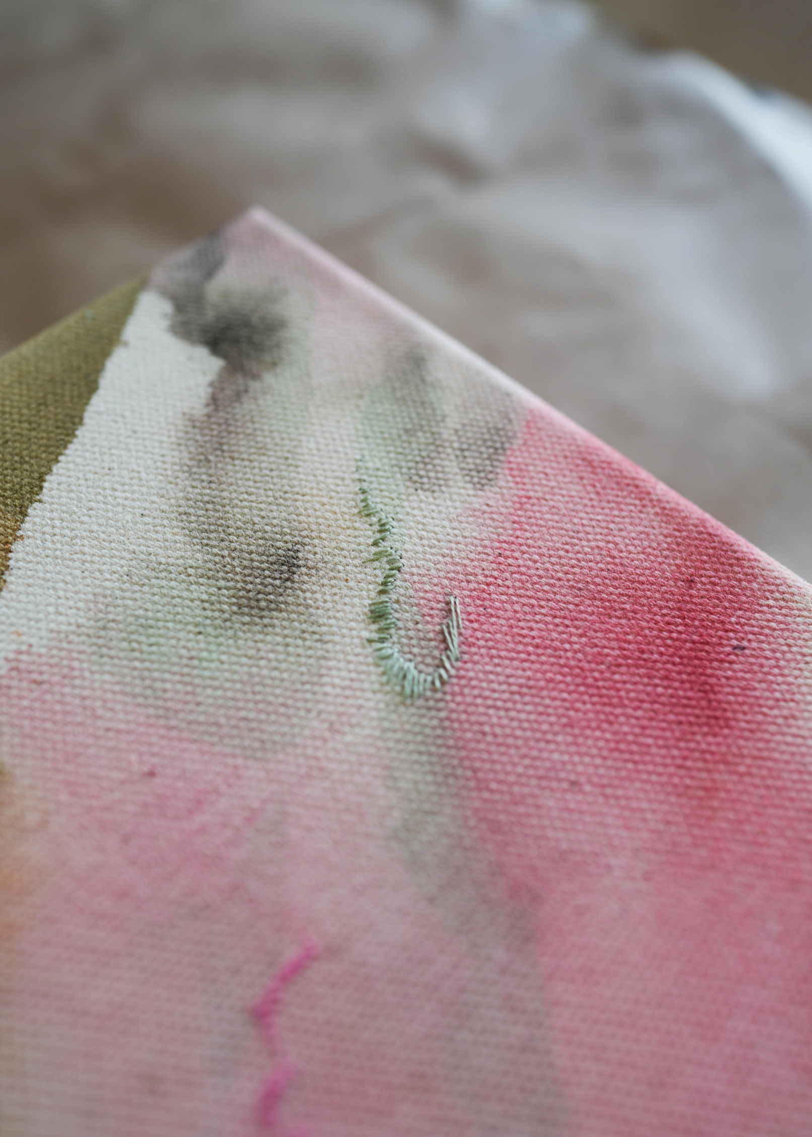 Abstract acrylic painting with pink, blue, and gray hues on raw canvas. Bordered by a wooden frame. Conveys a natural, ethereal mood.