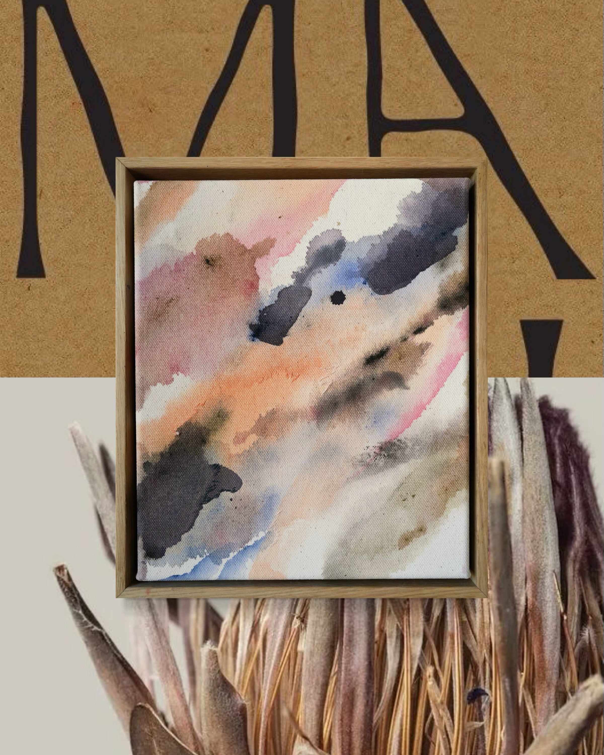 Framed abstract artwork with soft grey, pink, orange, and beige tones on a beige-brown backdrop.