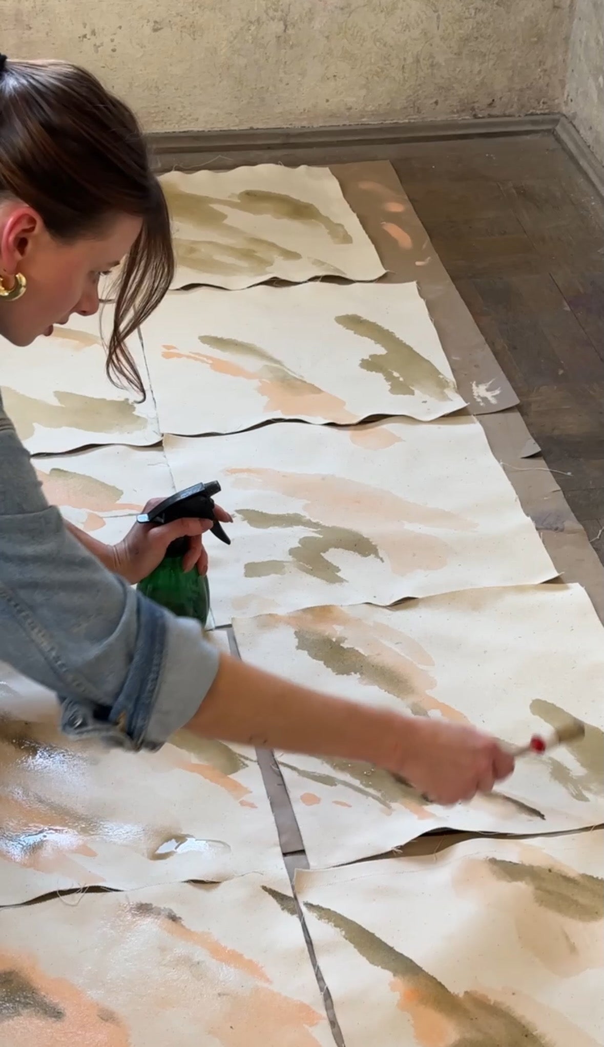 The artist working on multiple small canvases for her upcoming fine art collection about nostalgia.