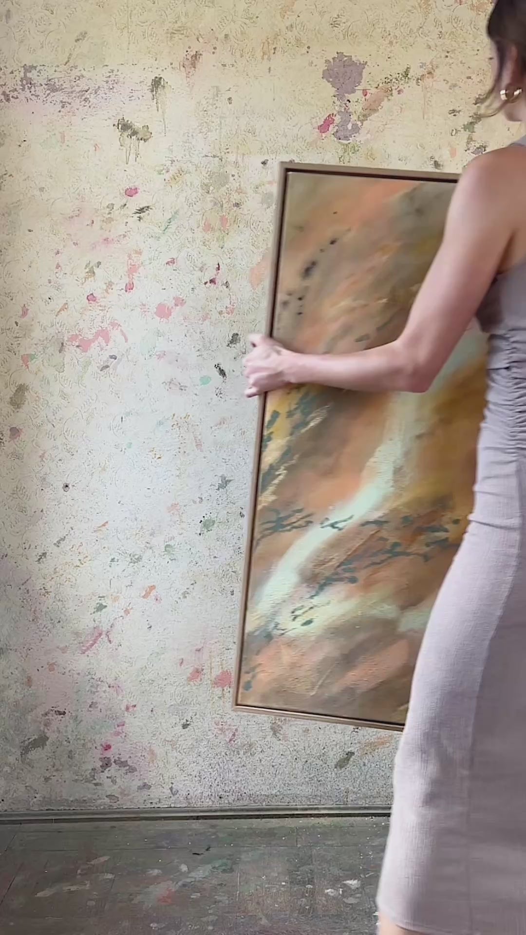 Abstrakt artwork featuring swirling patterns in earthy tones, orange, olive, yellow and pastel tones in turquoise and butter yellow on a textured surface framed in oak wood.