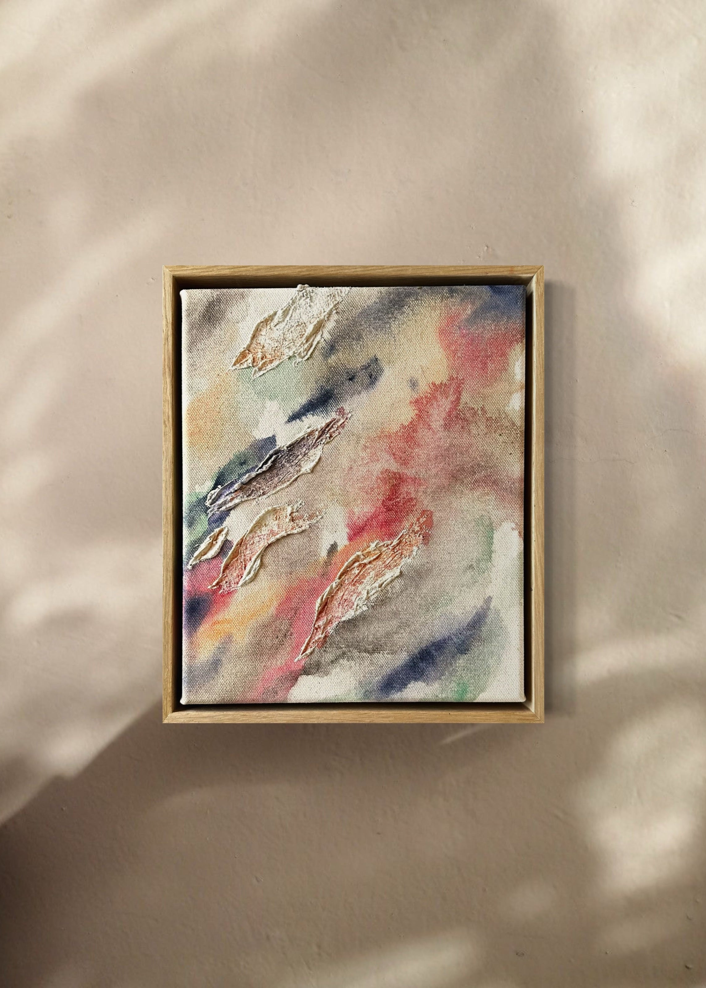 Abstract painting highlighted through organic shaped textures. Featuring colors of beige, pink, green, dark purple and deep blue on a canvas background. Framed in an oak wood frame. 