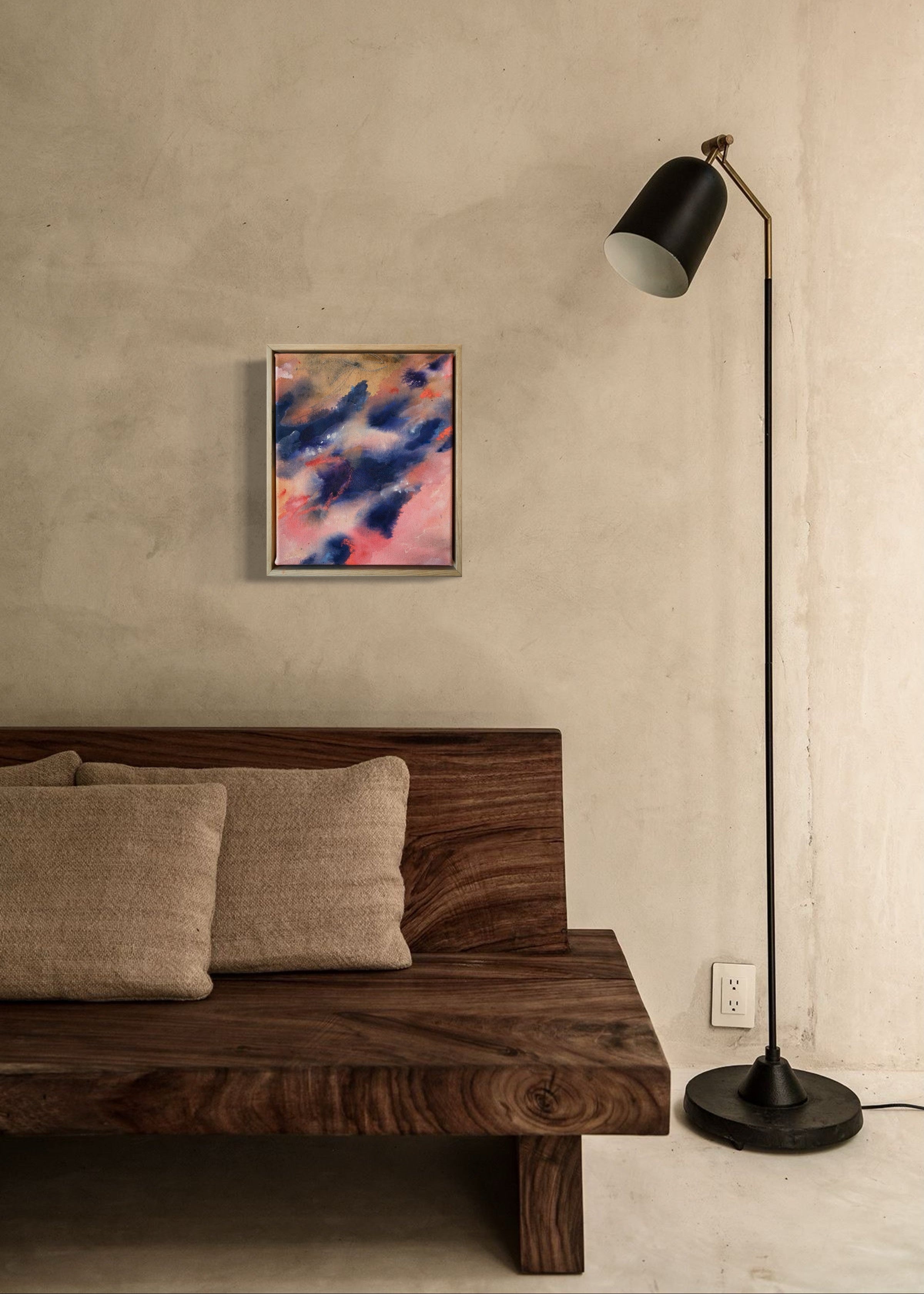 Abstract painting with swirling blue and pink tones, framed in wood, evoking motion and emotion.
