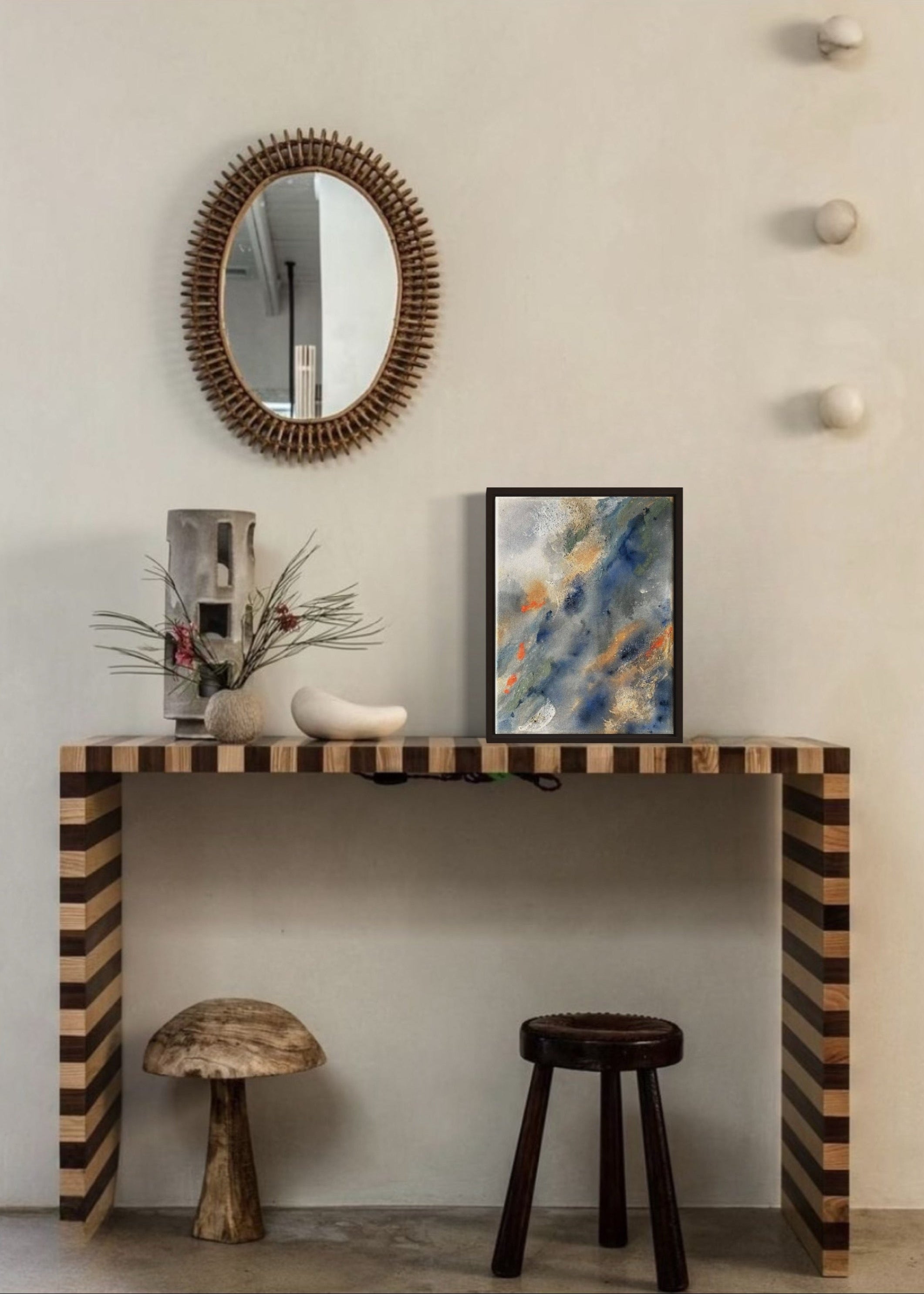 Abstract painting with swirling patterns in shades of blue, gray, green and orange, framed in oak wood.