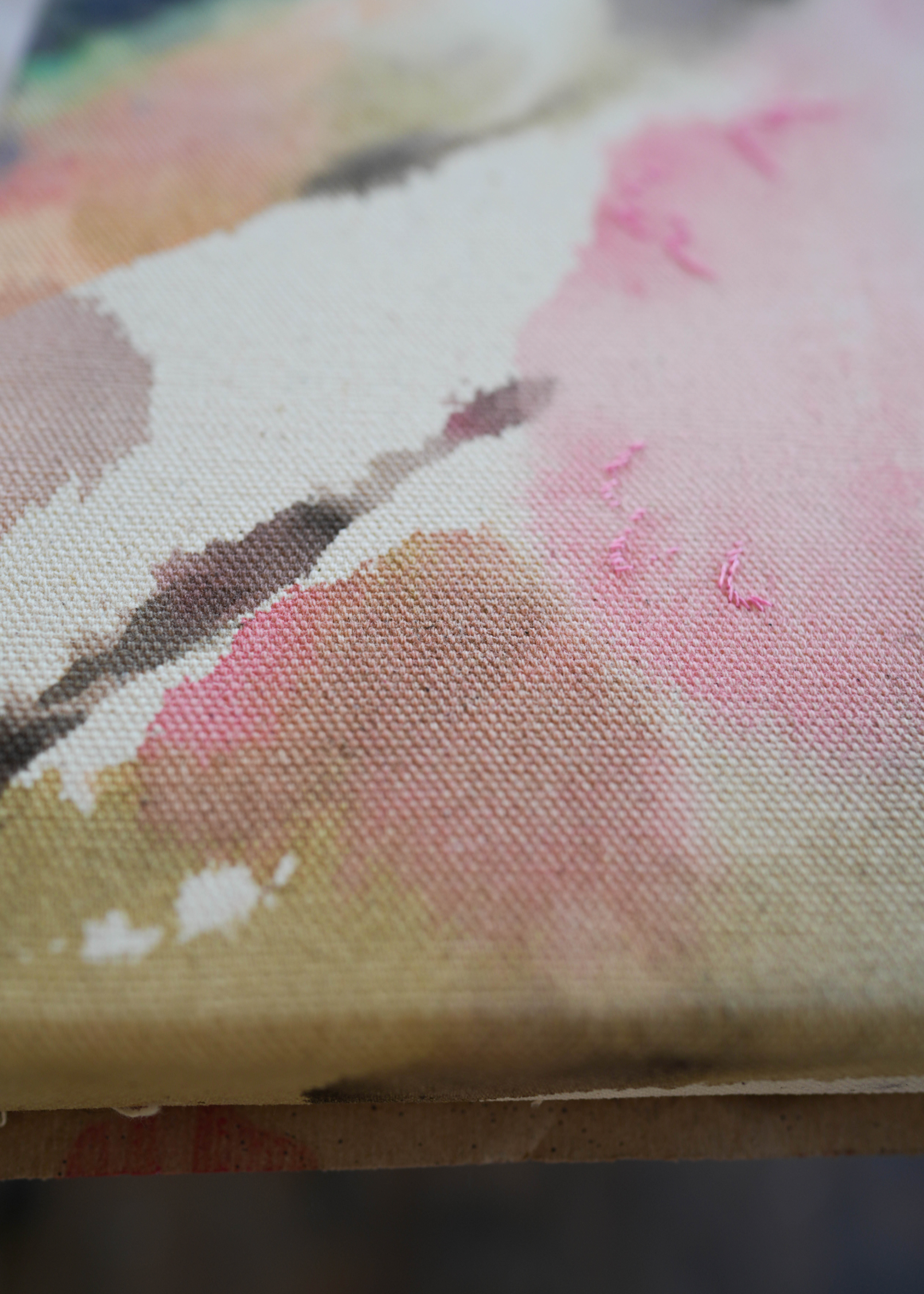 Abstract acrylic, fluid painting with soft pink, peach, green, and dark grey splashes, framed by light wood, conveying an impressionistic and soothing tone.