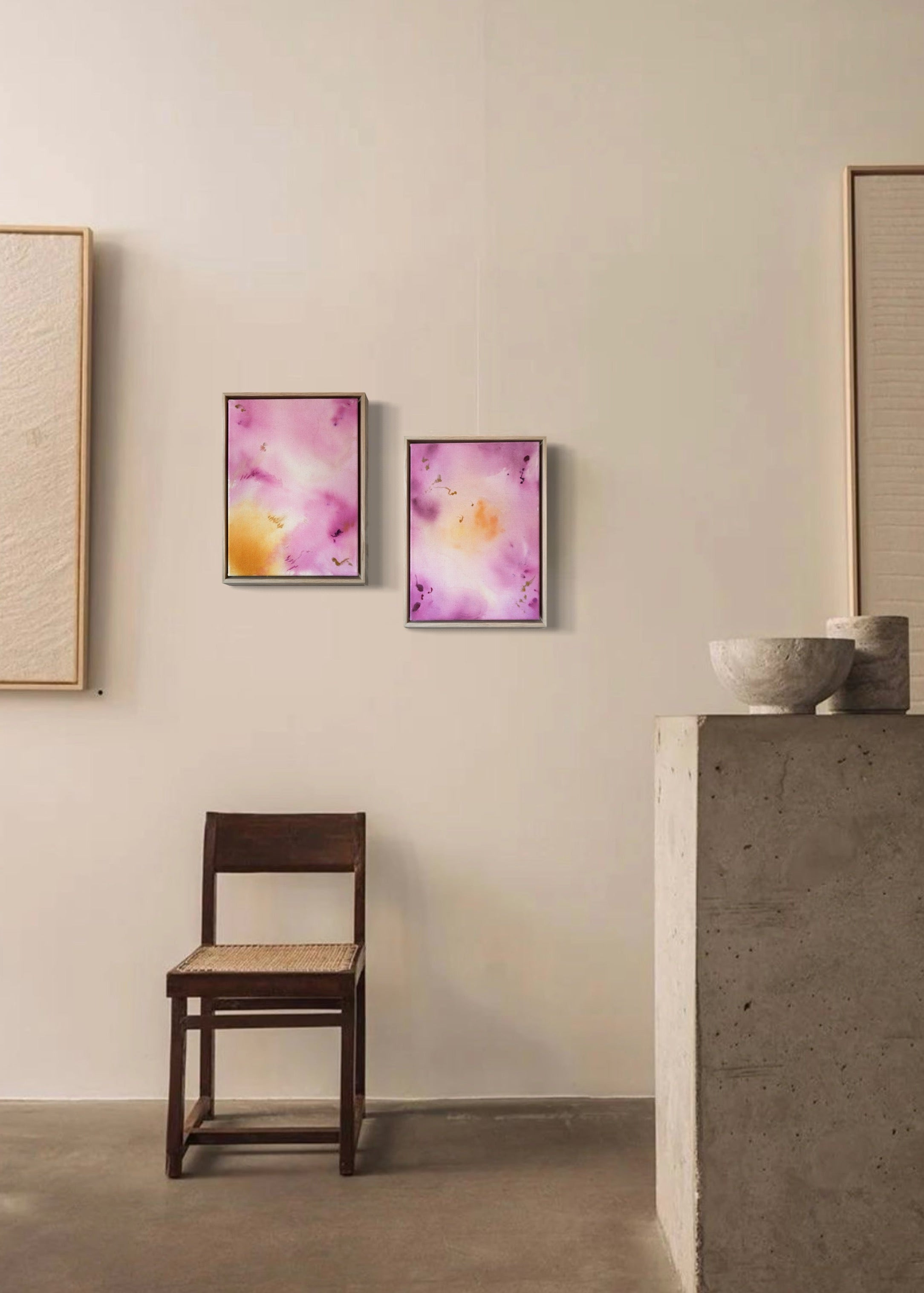 Abstract painting featuring soft pink, purple, and orange hues blending together with embroidery details of gold and dark purple on a canvas, framed in light wood.