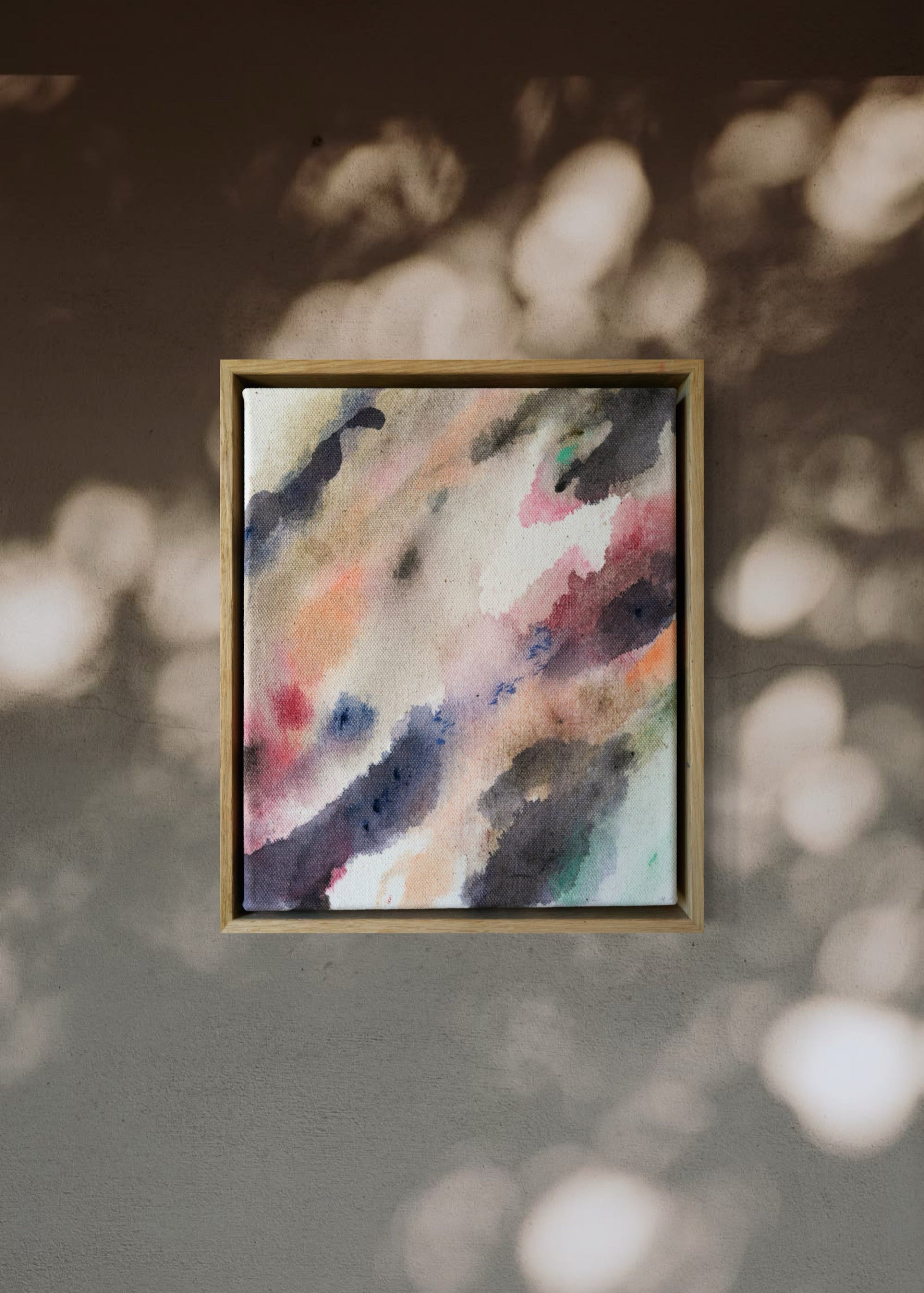 Abstract acrylic painting with flowing shades of pink, brown, and gray on canvas, in a wooden frame. The soft brushstrokes convey a soothing, dreamy emotion.