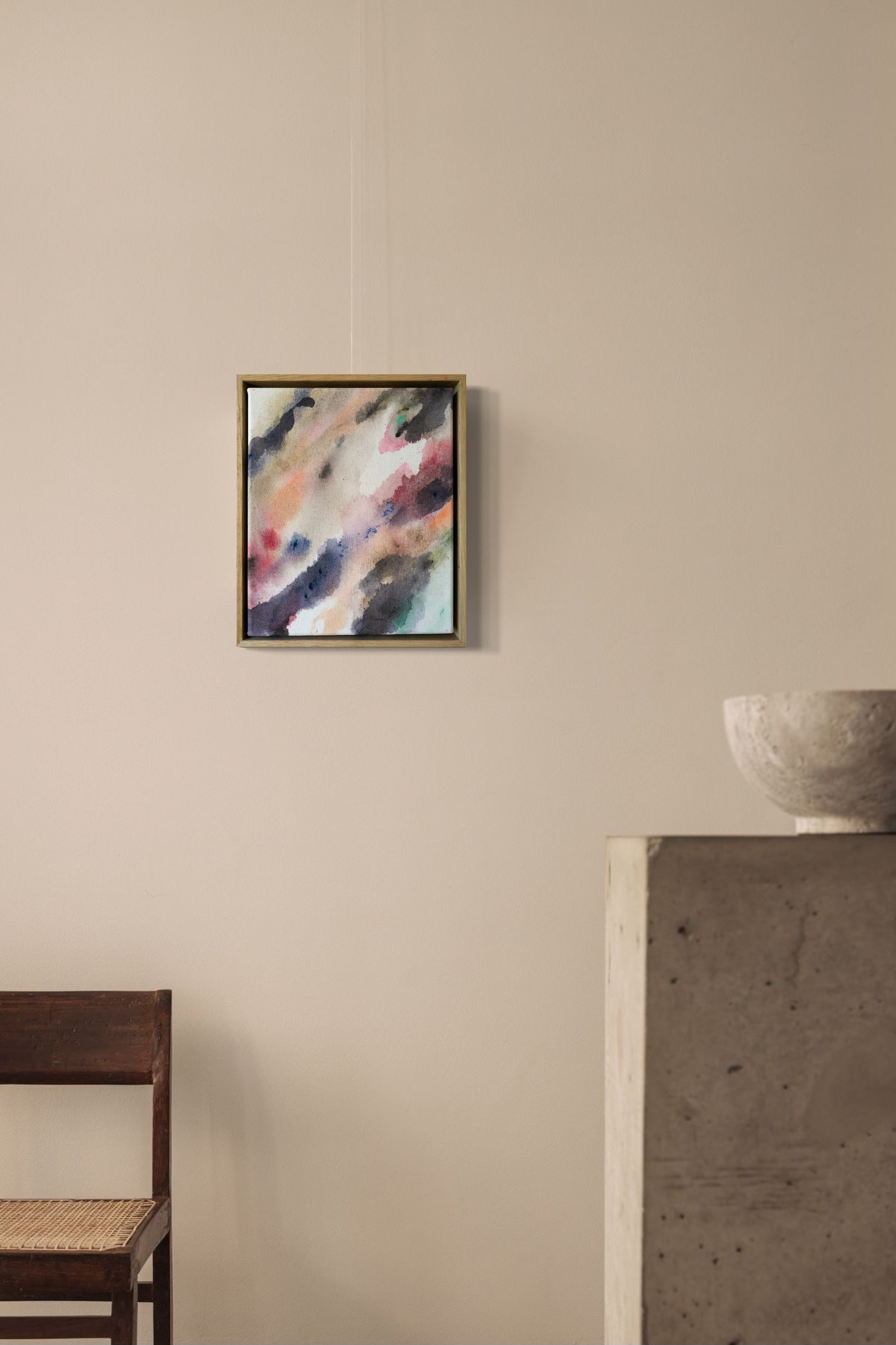 Abstract acrylic painting with flowing shades of pink, brown, and gray on canvas, in a wooden frame. The soft brushstrokes convey a soothing, dreamy emotion.
