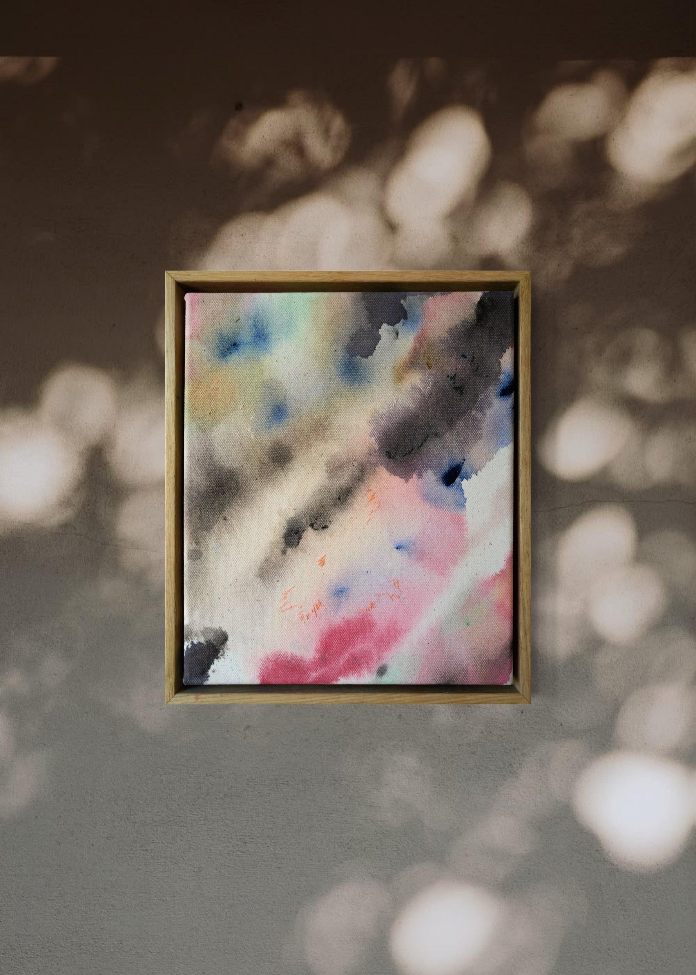 Abstract acrylic, fuid painting in a wooden frame, featuring soft blends of pink, blue, and dark grey. Conveys a dreamy, ethereal mood.