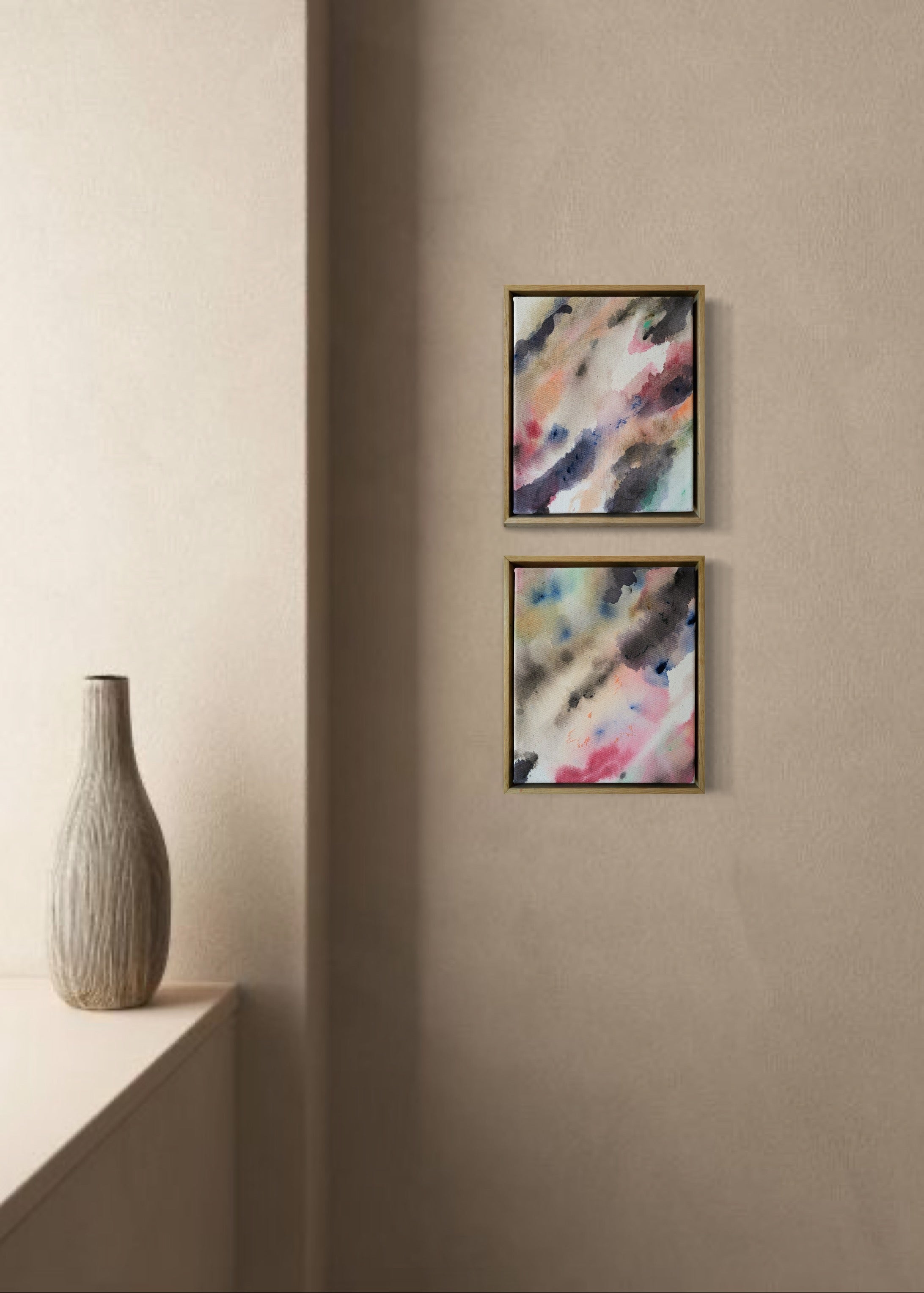 Abstract acrylic, fuid painting in a wooden frame, featuring soft blends of pink, blue, and dark grey. Conveys a dreamy, ethereal mood.