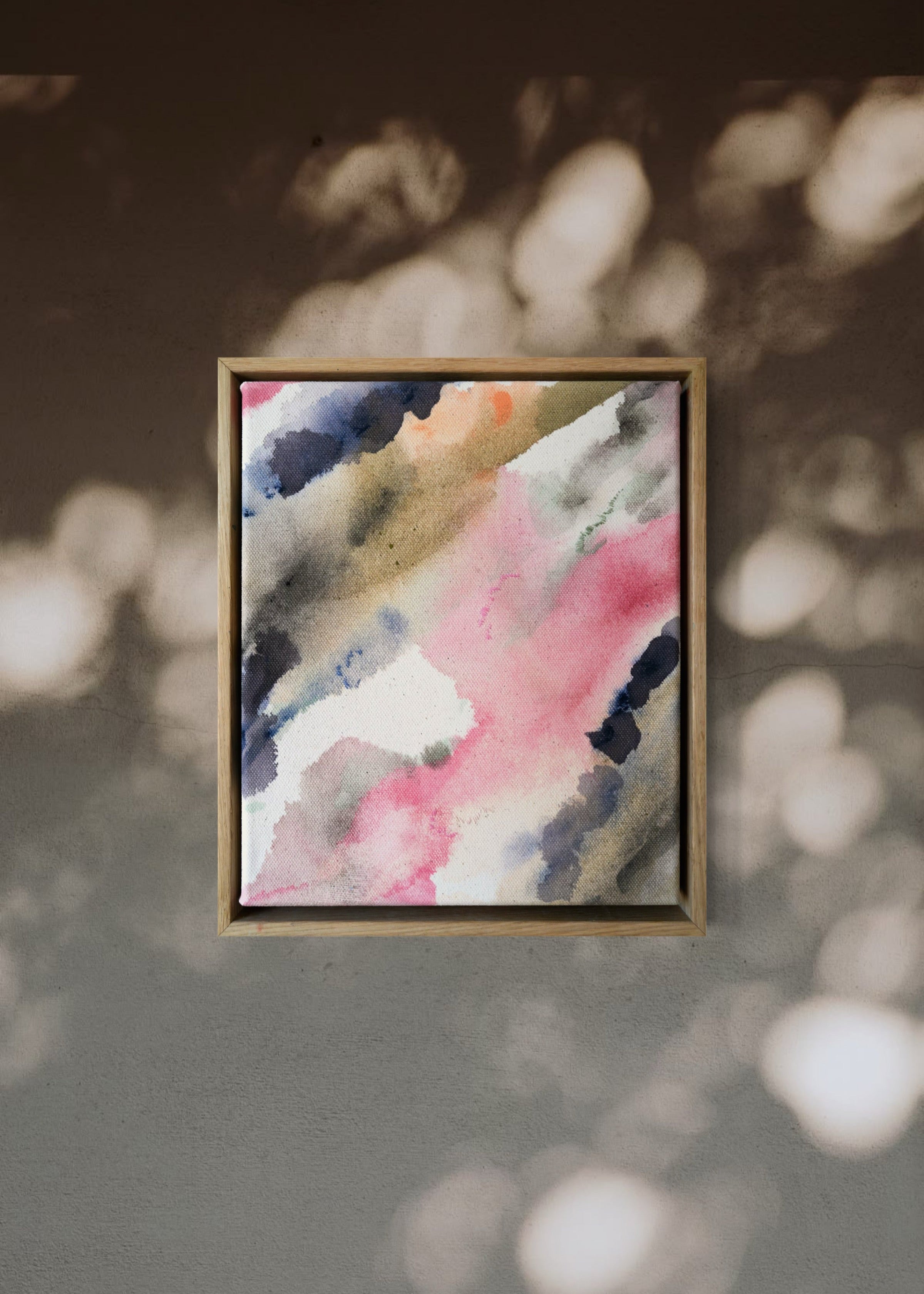 Abstract acrylic painting with pink, blue, and gray hues on raw canvas. Bordered by a wooden frame. Conveys a natural, ethereal mood.