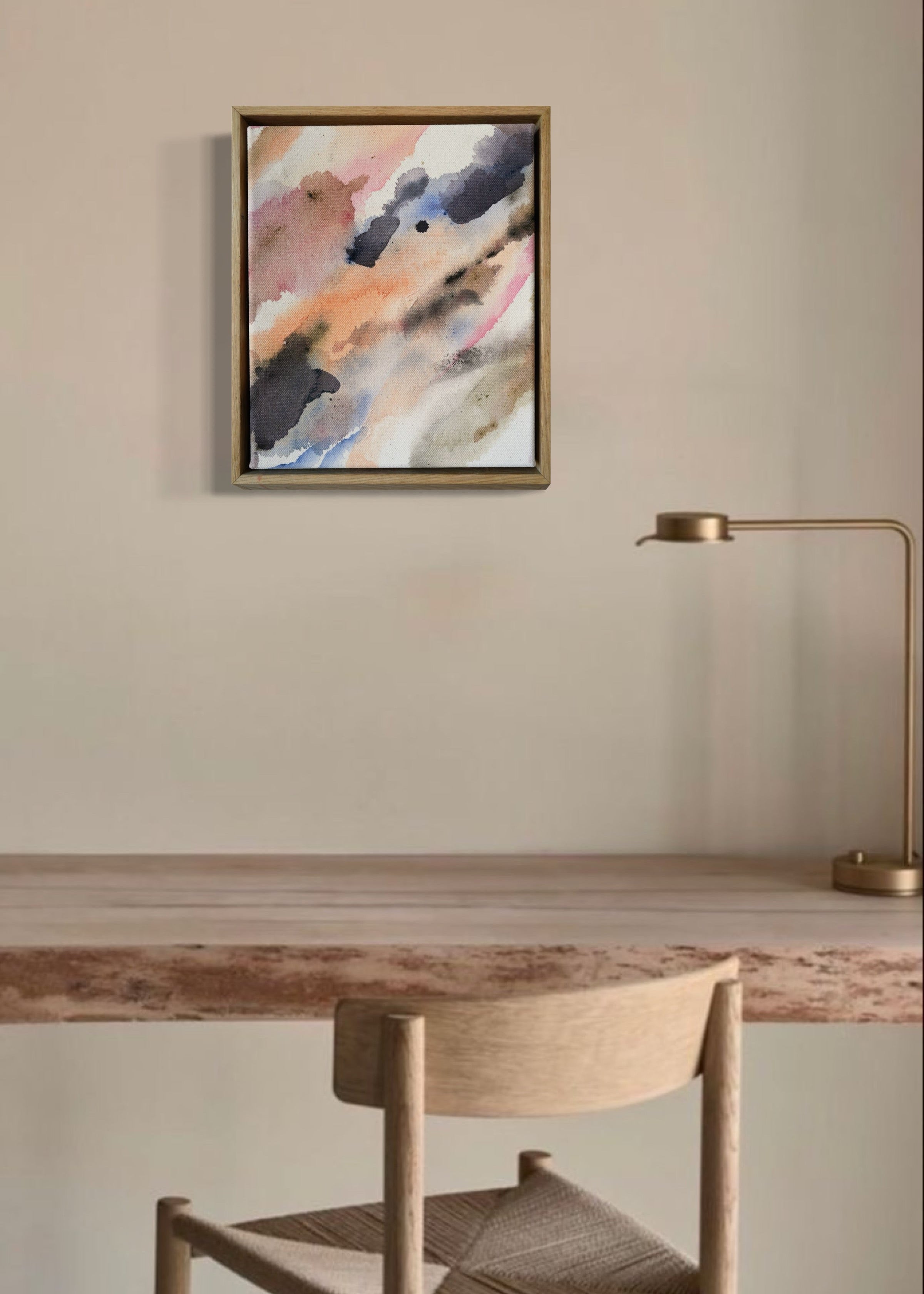 Abstract acrylic painting with soft, flowing shades of pink, peach, gray, and blue. Framed in light wood, the art conveys a calm, dreamy atmosphere.