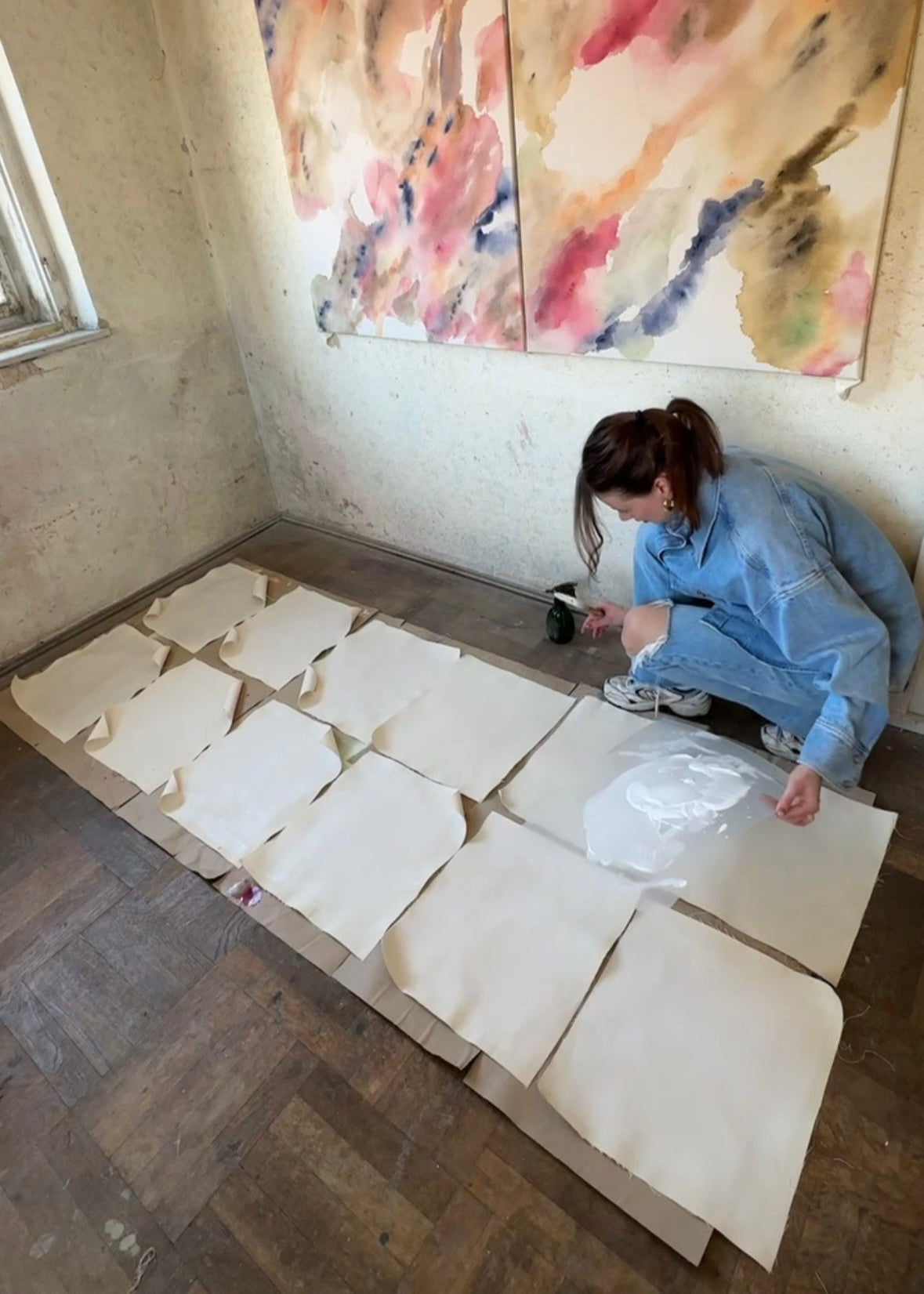 The artist working on multiple small canvases for her upcoming fine art collection about nostalgia.