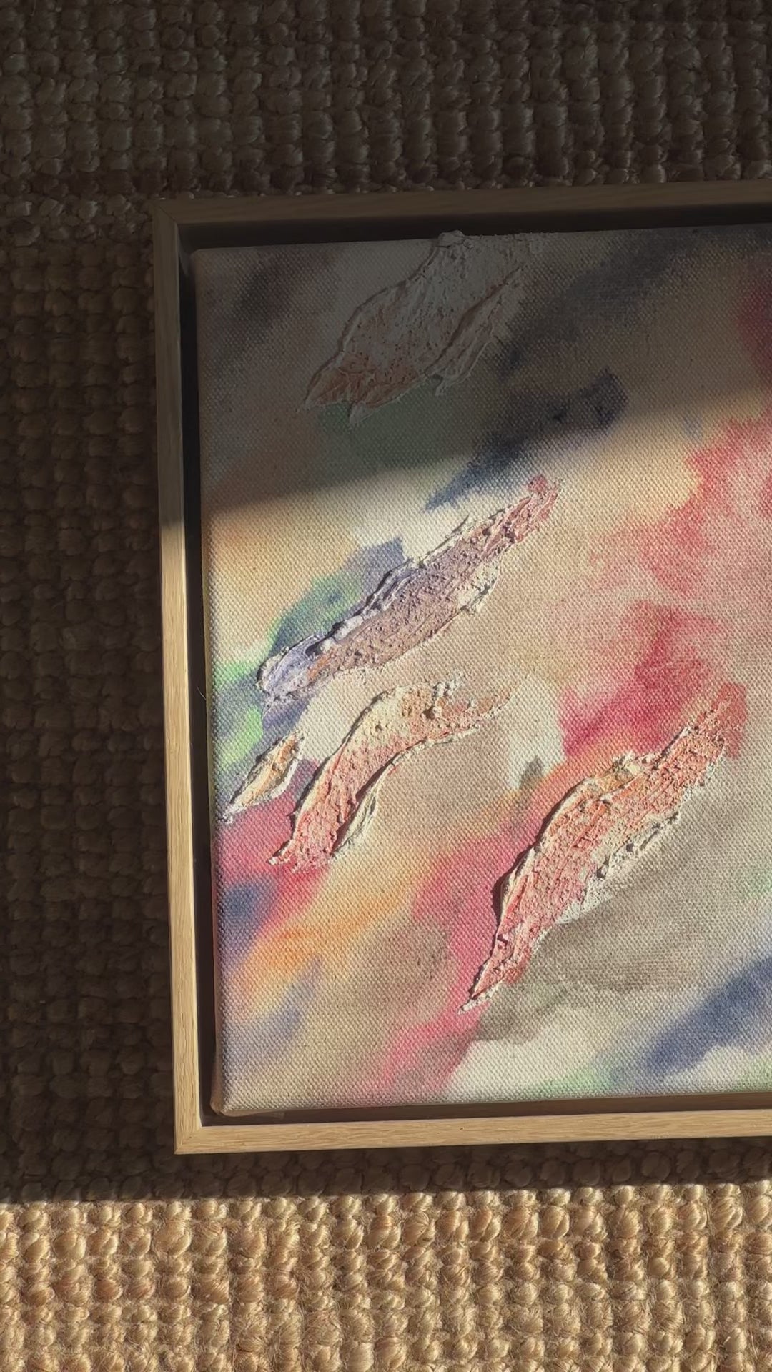 Abstract painting highlighted through organic shaped textures. Featuring colors of beige, pink, green, dark purple and deep blue on a canvas background. Framed in an oak wood frame. 