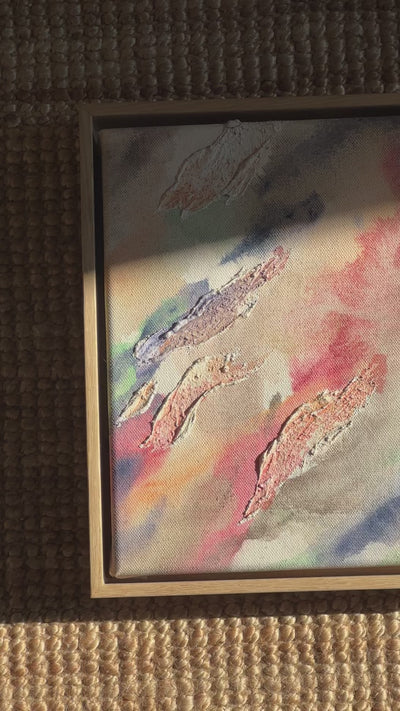 Abstract painting highlighted through organic shaped textures. Featuring colors of beige, pink, green, dark purple and deep blue on a canvas background. Framed in an oak wood frame. 