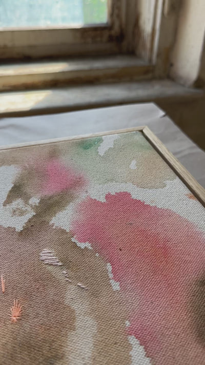 Abstract painting featuring soft, flowing shapes in shades of pink, beige, orange, and green shades, with a textured appearance  framed in oak wood.